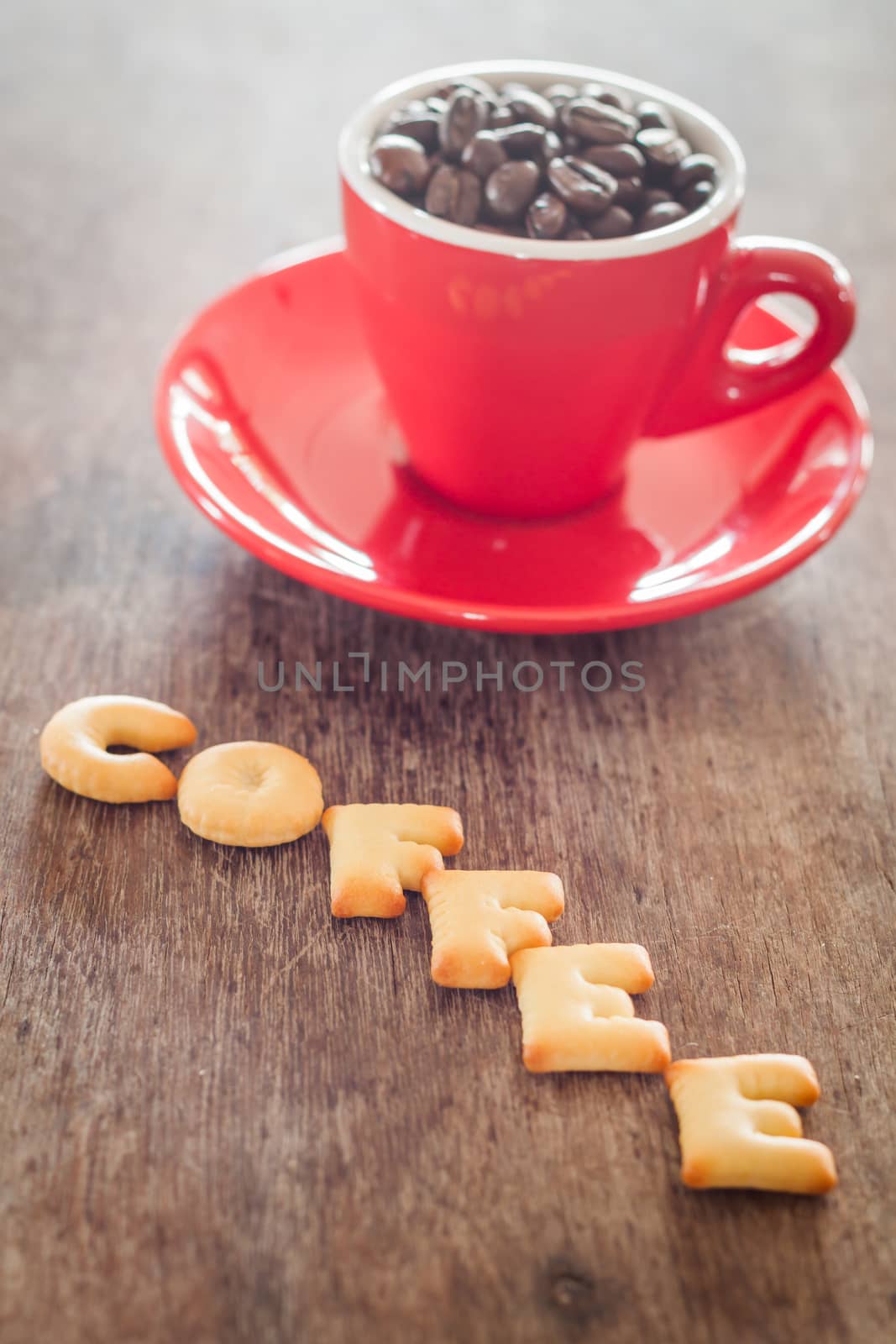 Coffee alphabet biscuit with red coffee cup by punsayaporn