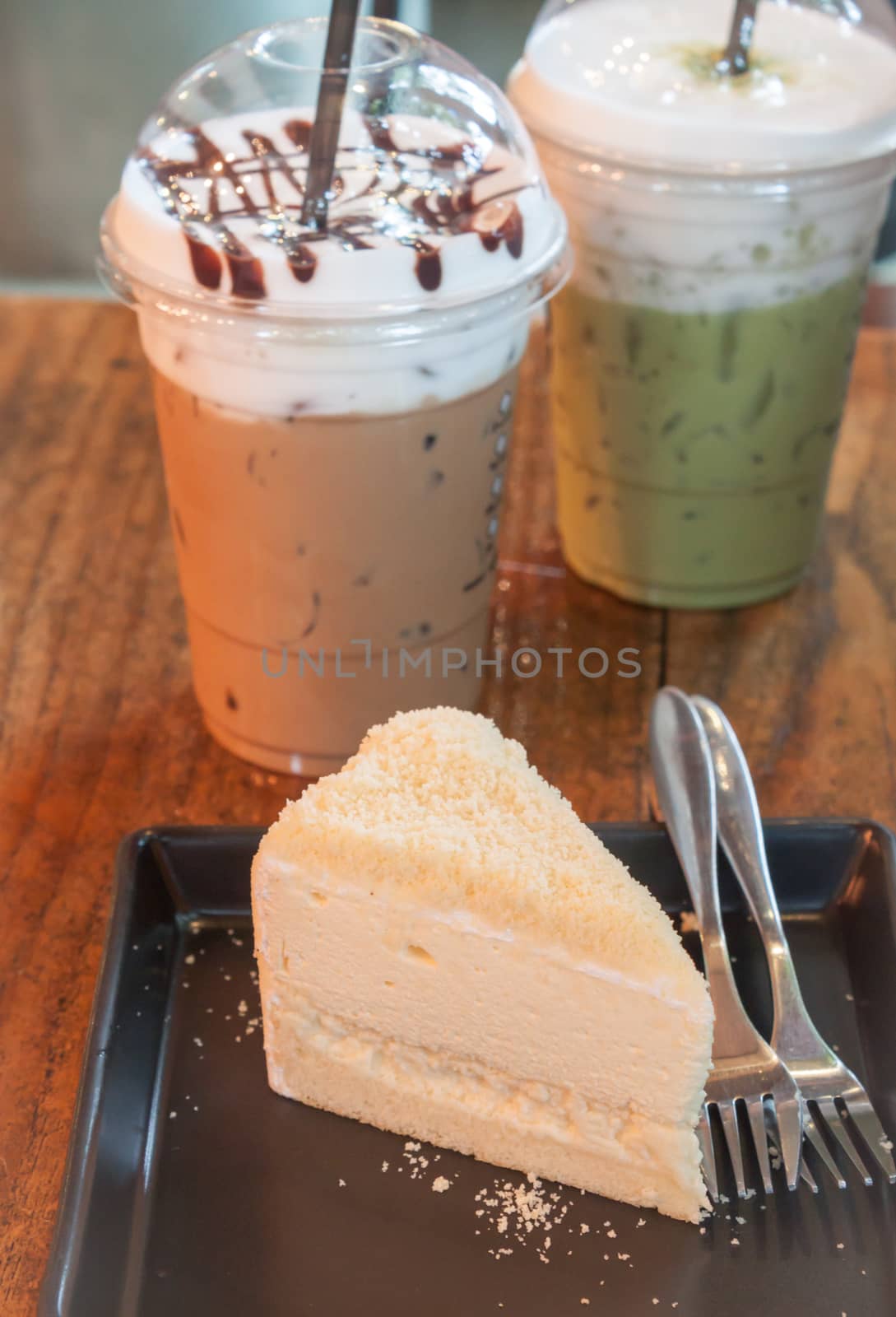 Take-home ice coffee cup on wooden table by punsayaporn