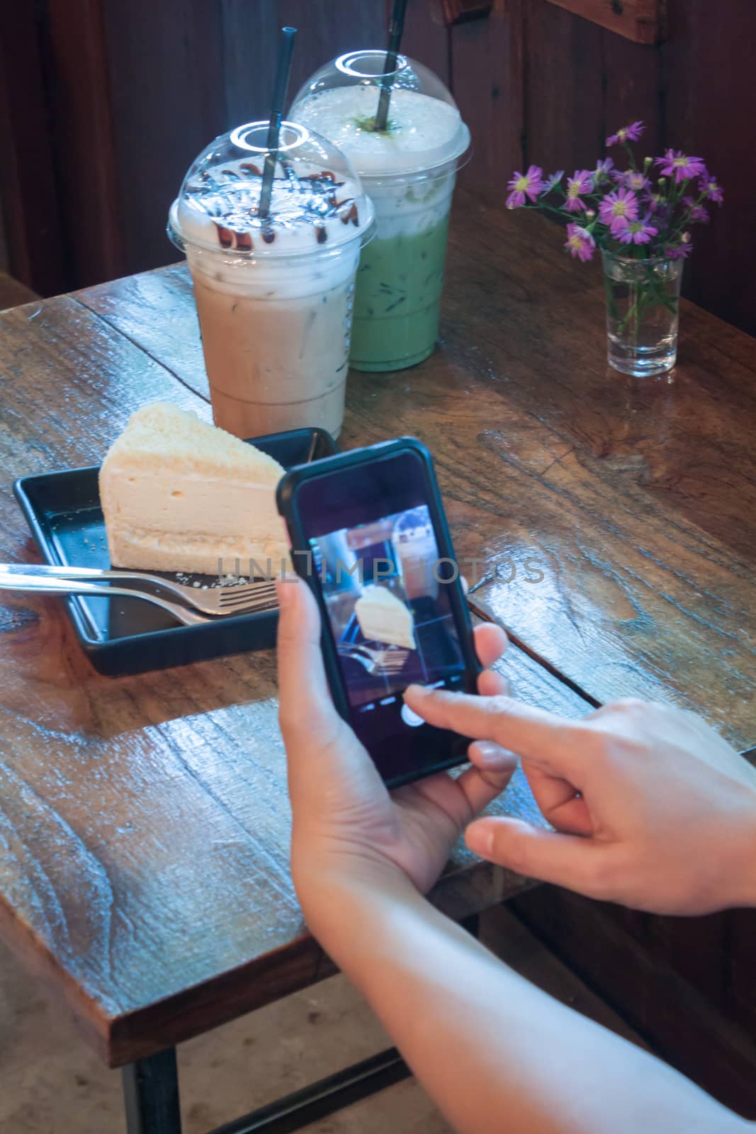 Closeup woman using smartphone in coffee shop, stock photo