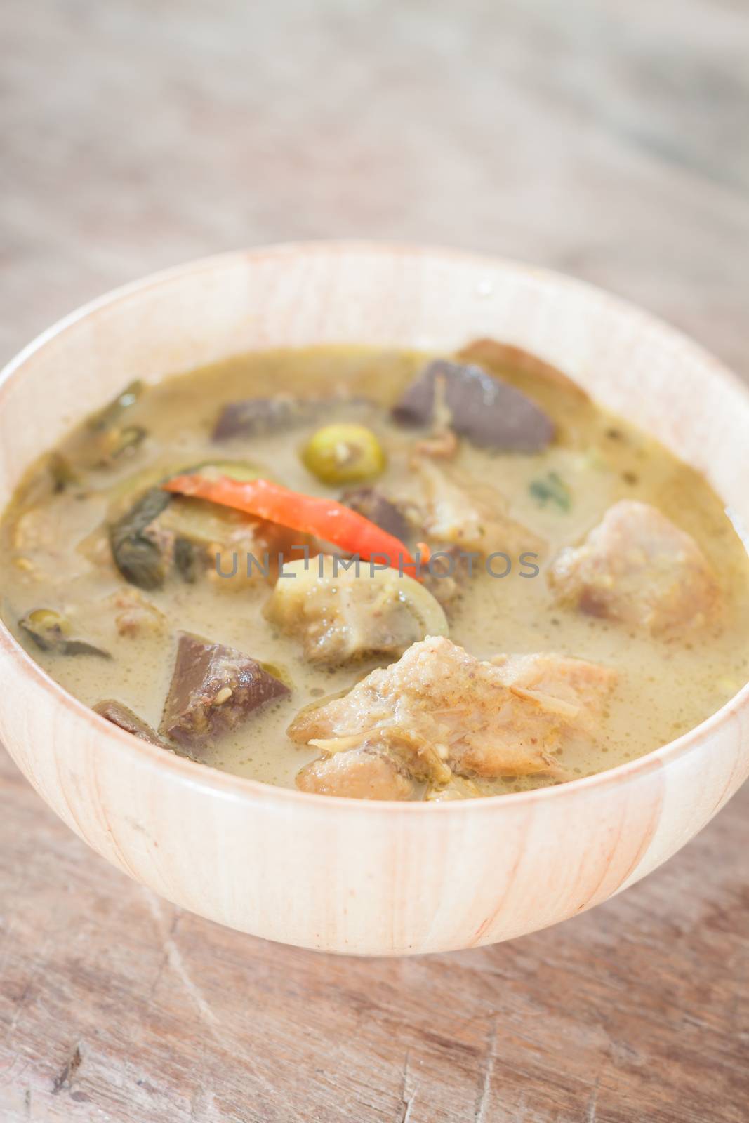 Grren curry in wooden bowl, stock photo