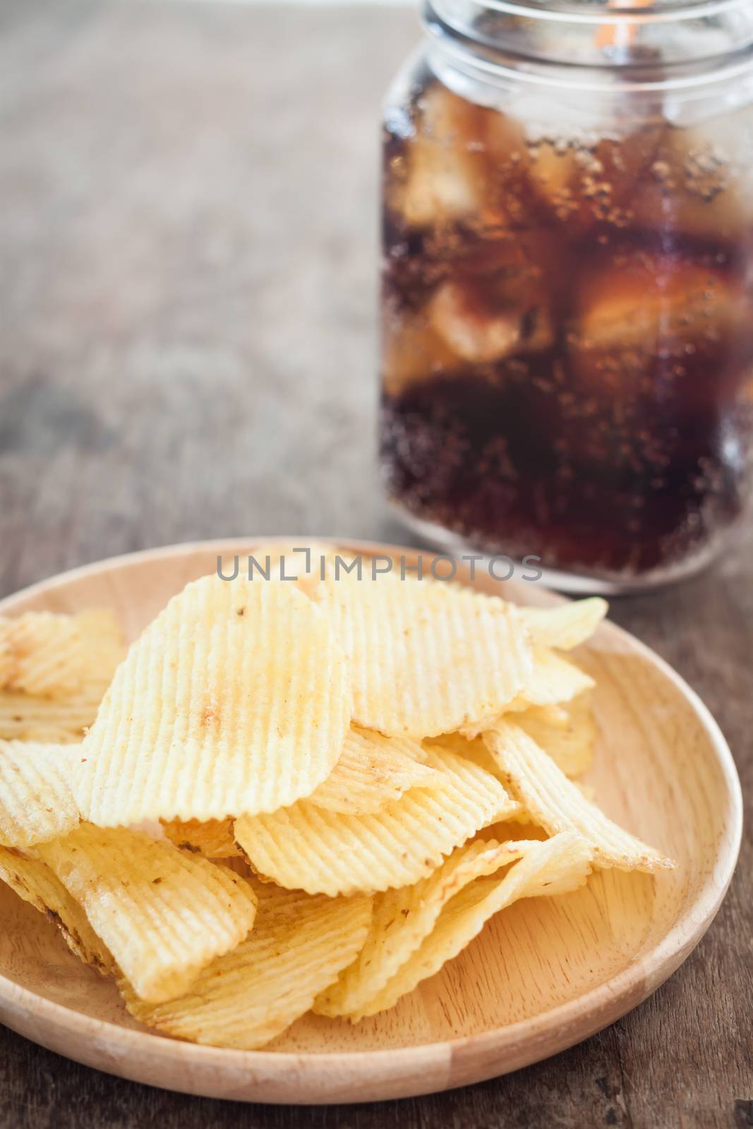 Crispy potato chips with iced cola, stock photo