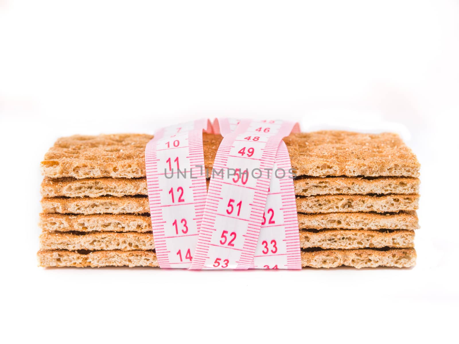 Diet Crispbread and measuring tape isolated on white. Diet concept