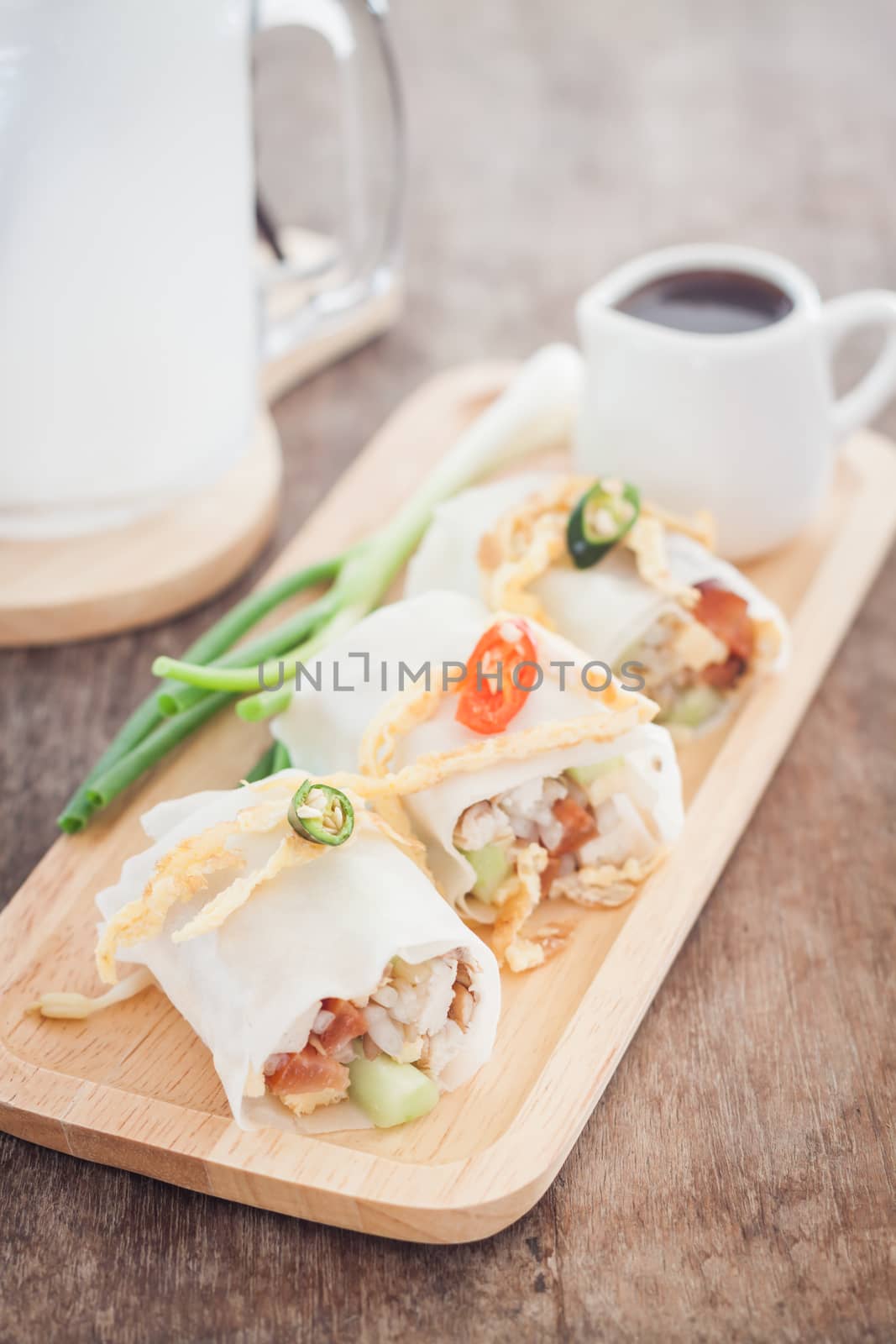 Fresh spring rolls on wooden table by punsayaporn