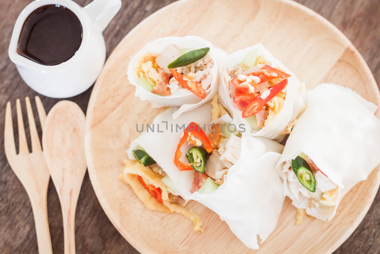 Fresh spring rolls on wooden table, stock photo