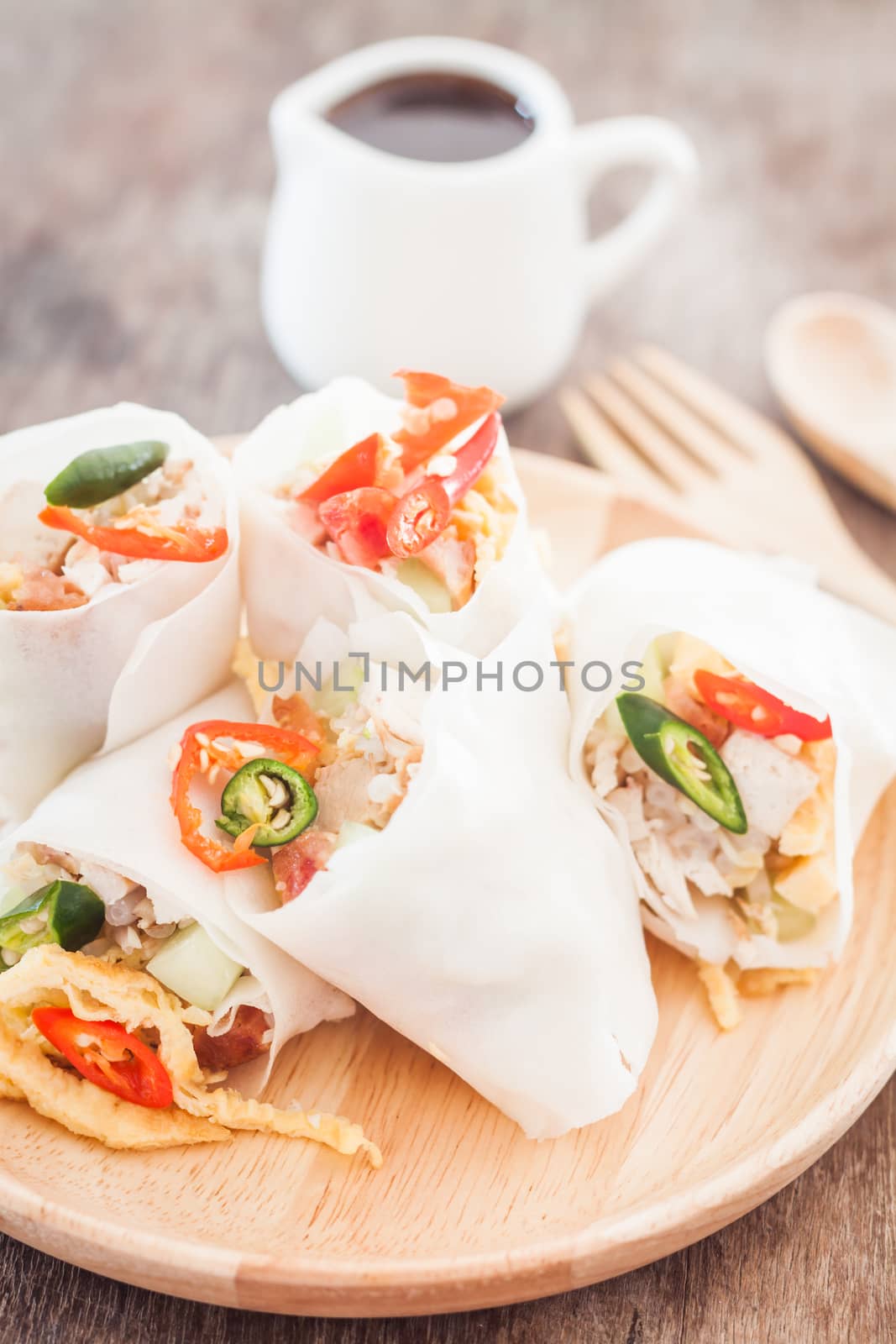 Fresh spring rolls on wooden table, stock photo