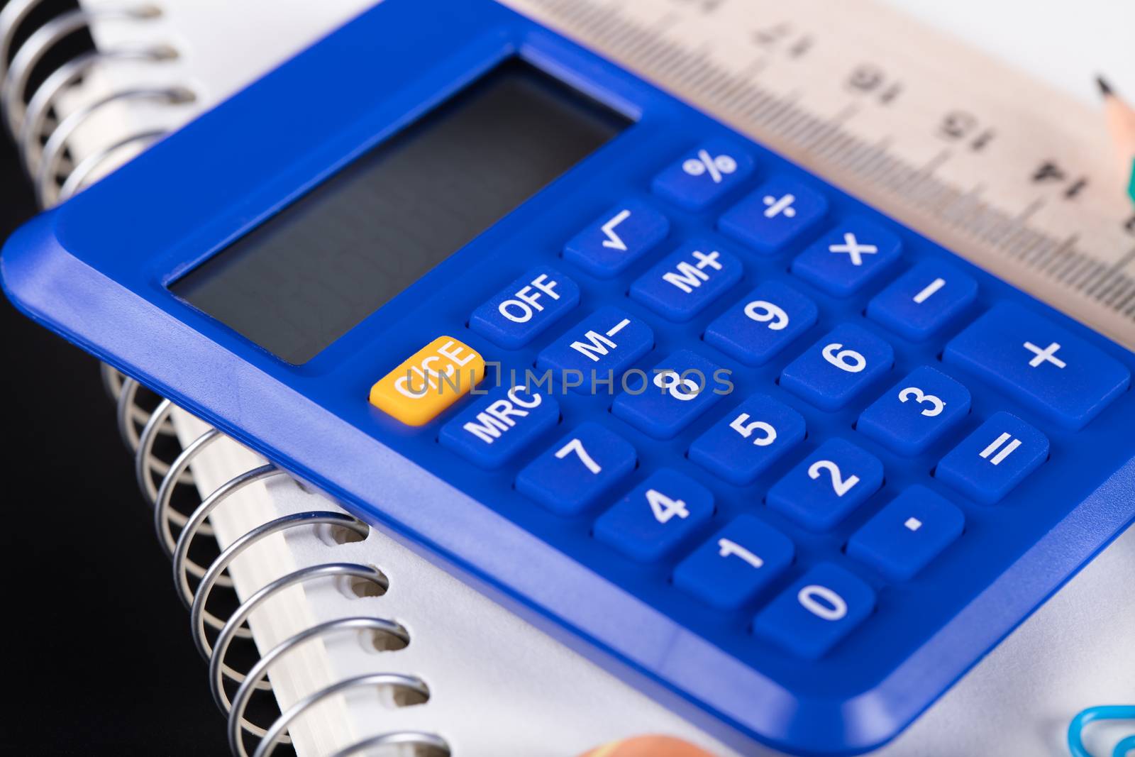 calculator and Office supplies close-up on a black background