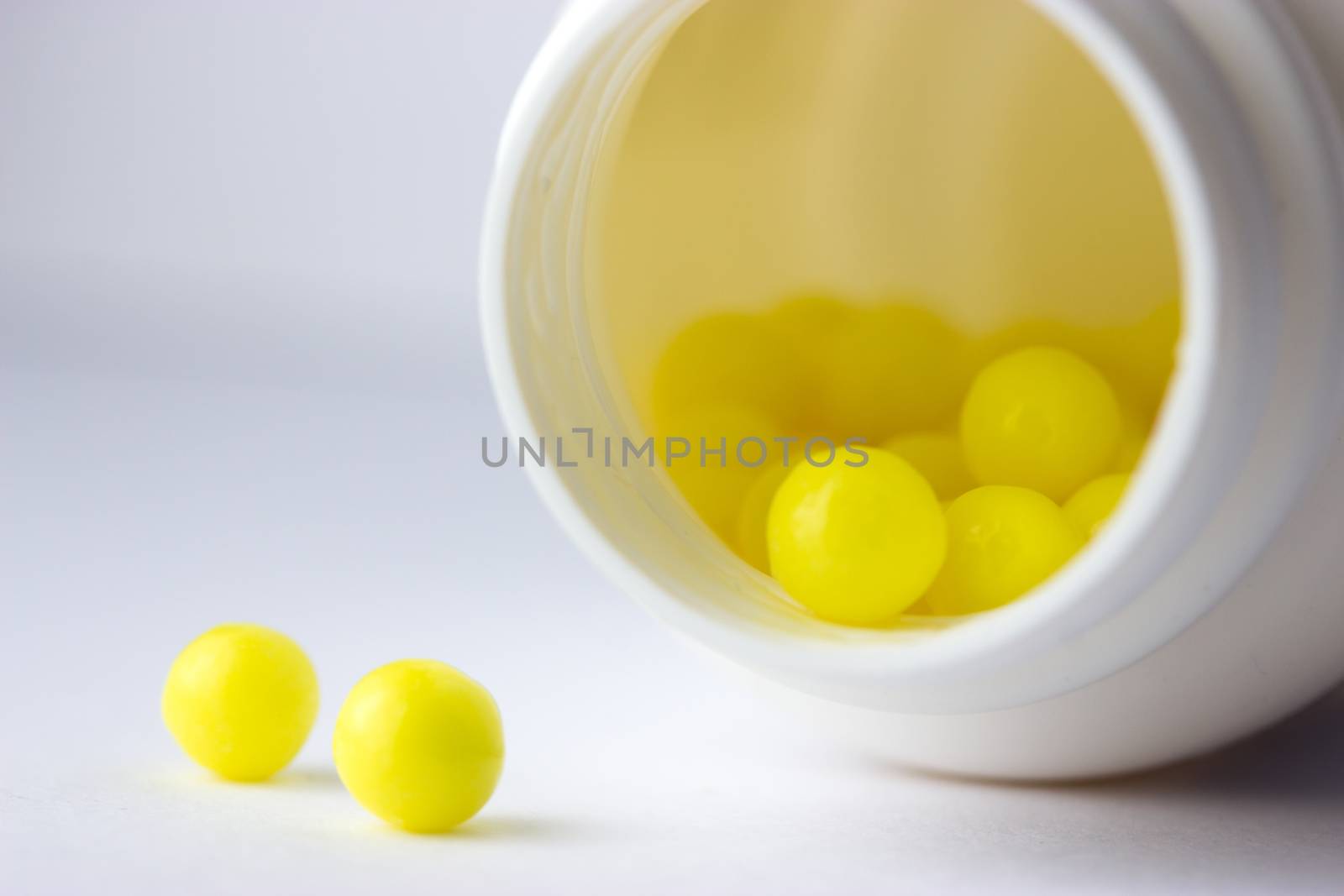 open bottle with yellow pills (not isolated)