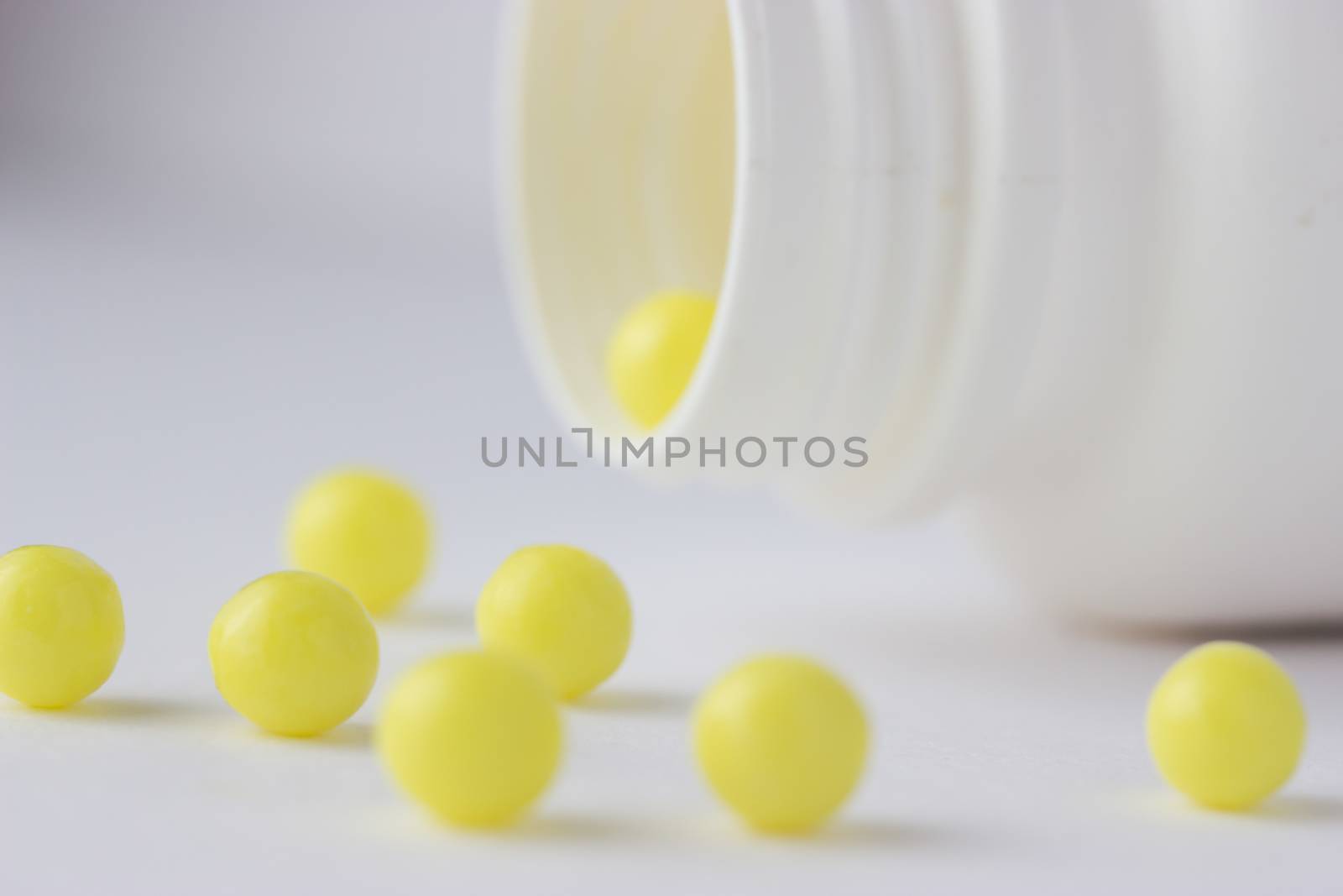 open bottle with yellow pills  by liwei12