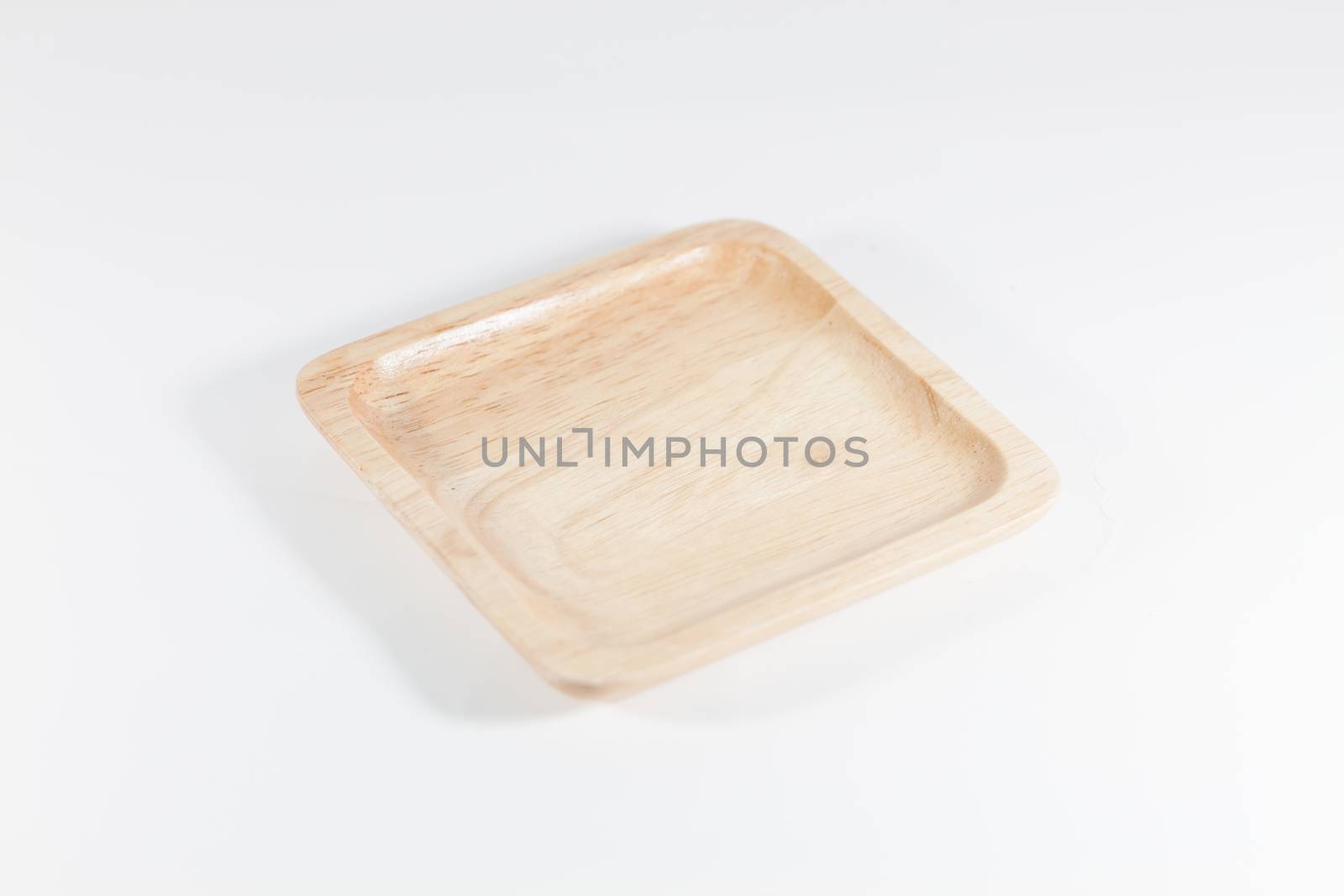 Wooden plate isolated on white background, stock photo
