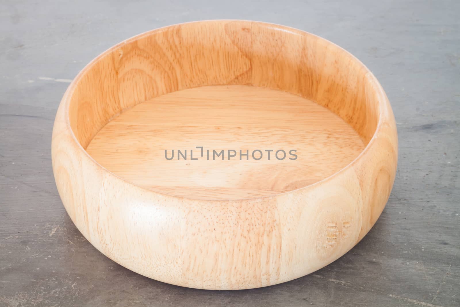 Wooden plate on grey background, stock photo