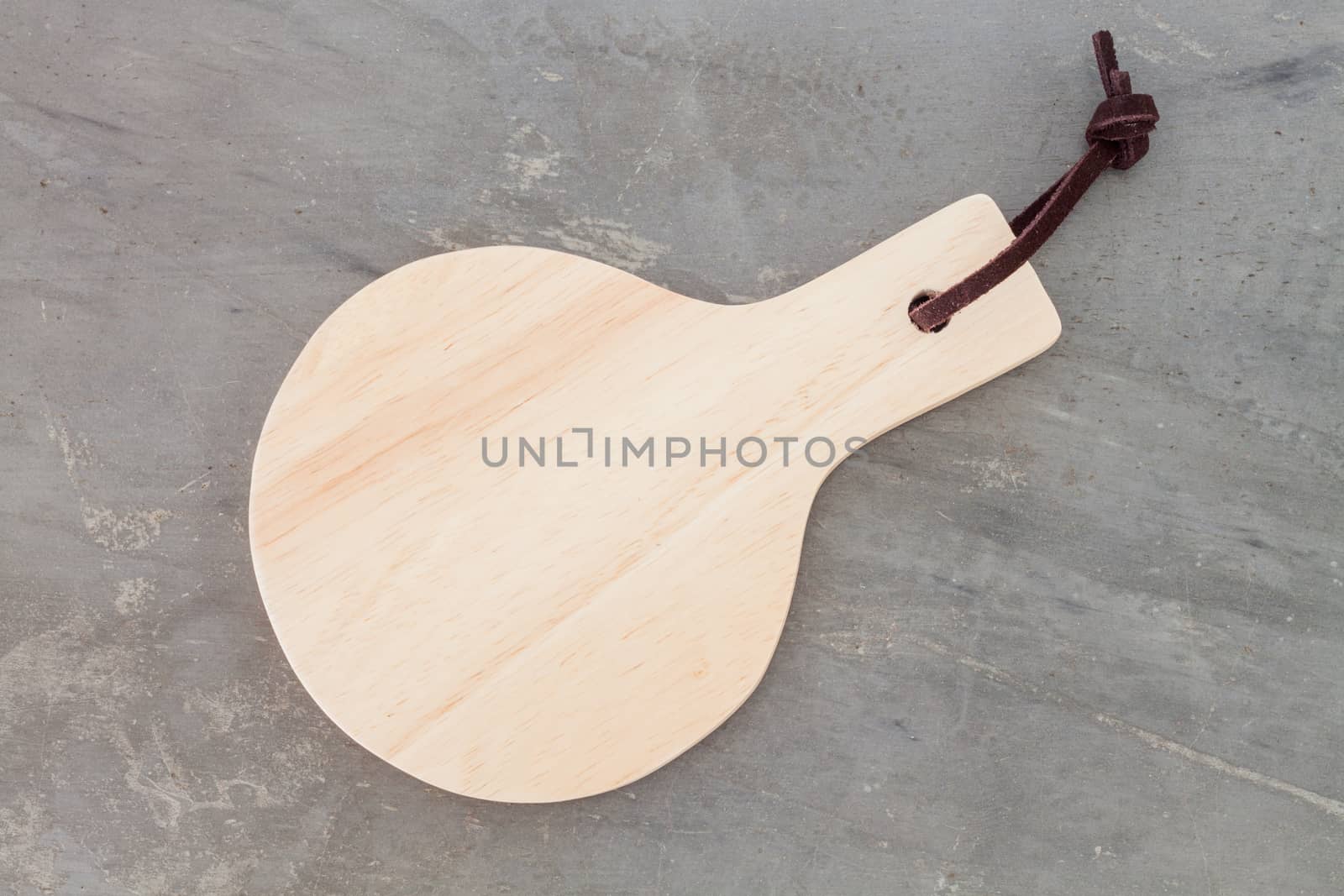Wooden plate on grey background, stock photo