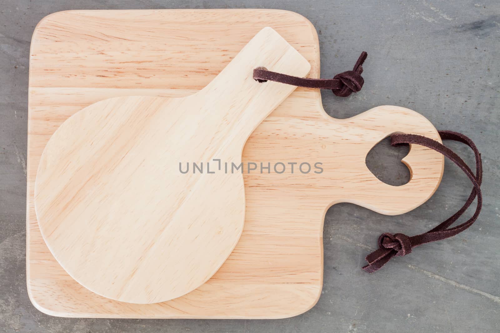 Wooden plate on grey background, stock photo