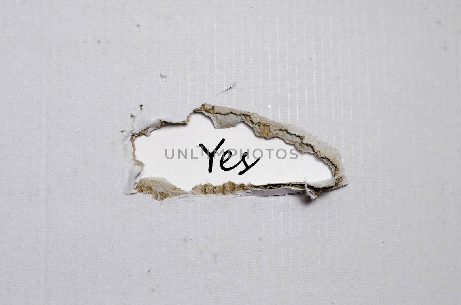 The word yes appearing behind torn paper