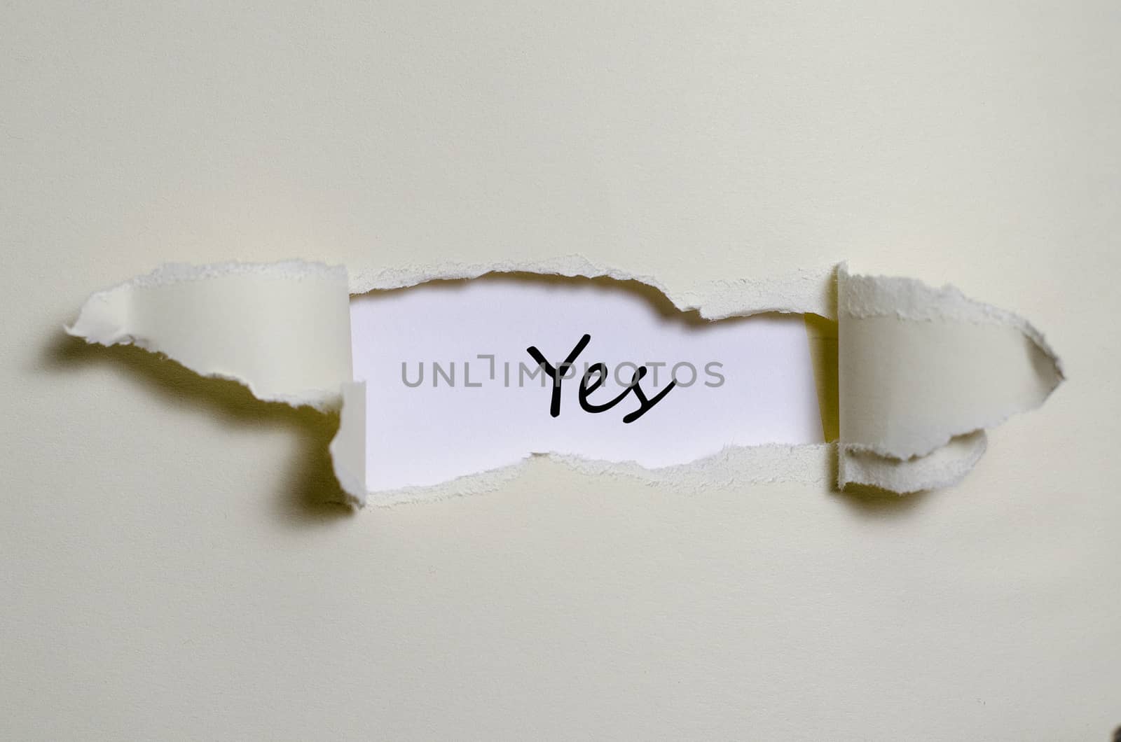 The word yes appearing behind torn paper by eenevski