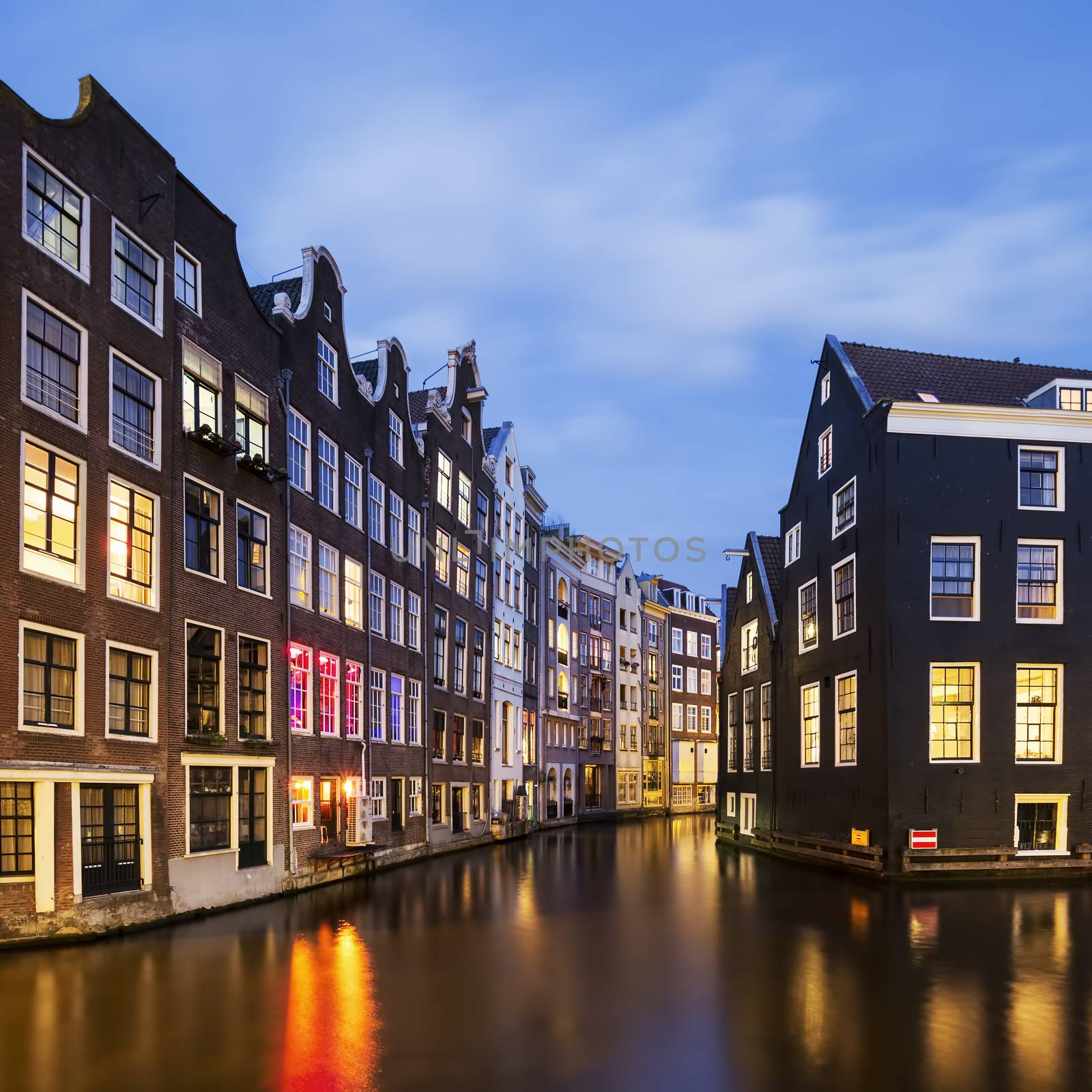 View of famous amsterdam canal by night by vwalakte