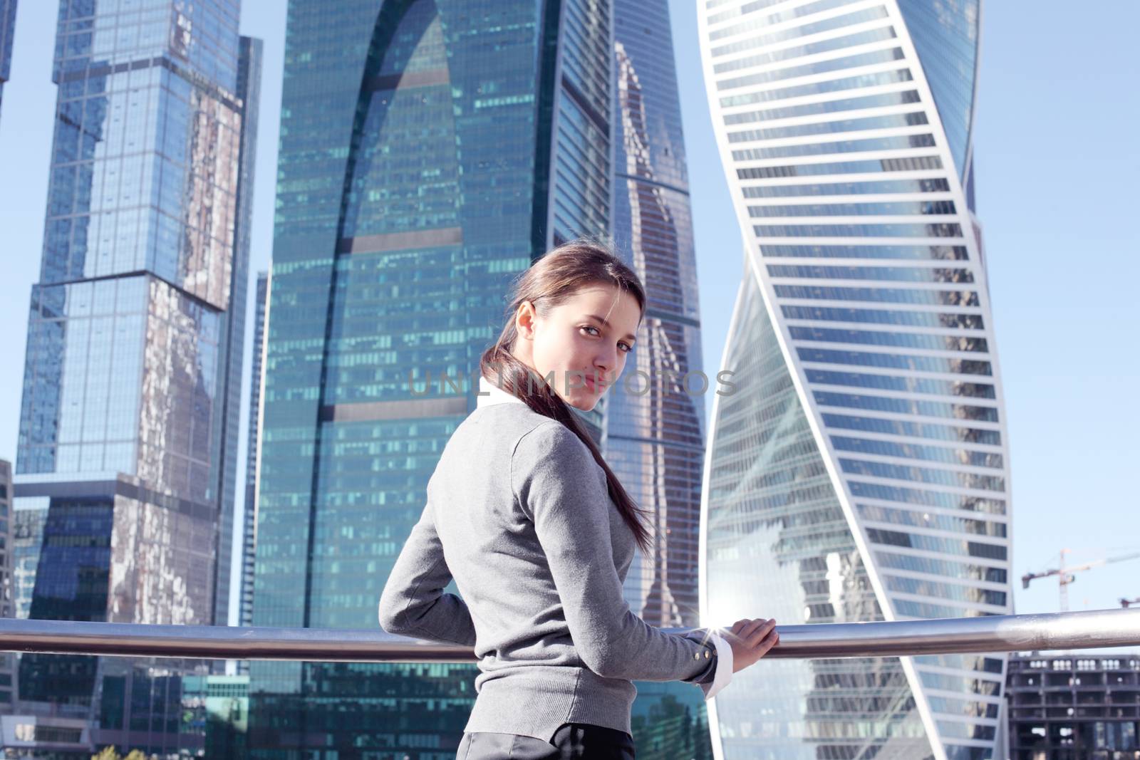 Young beautiful businesswoman outdoors at skyscraper background