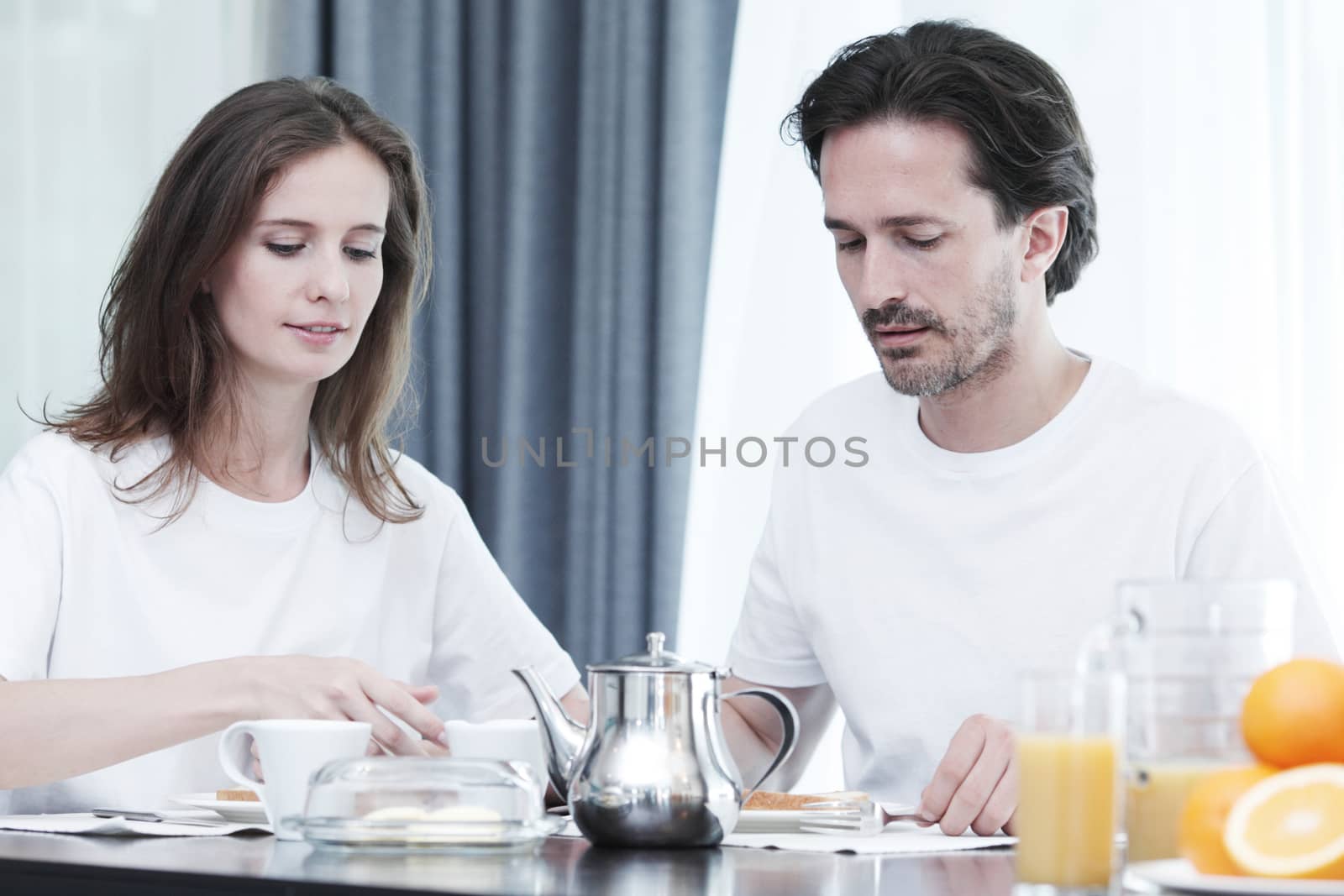 Couple having breakfast together at home 