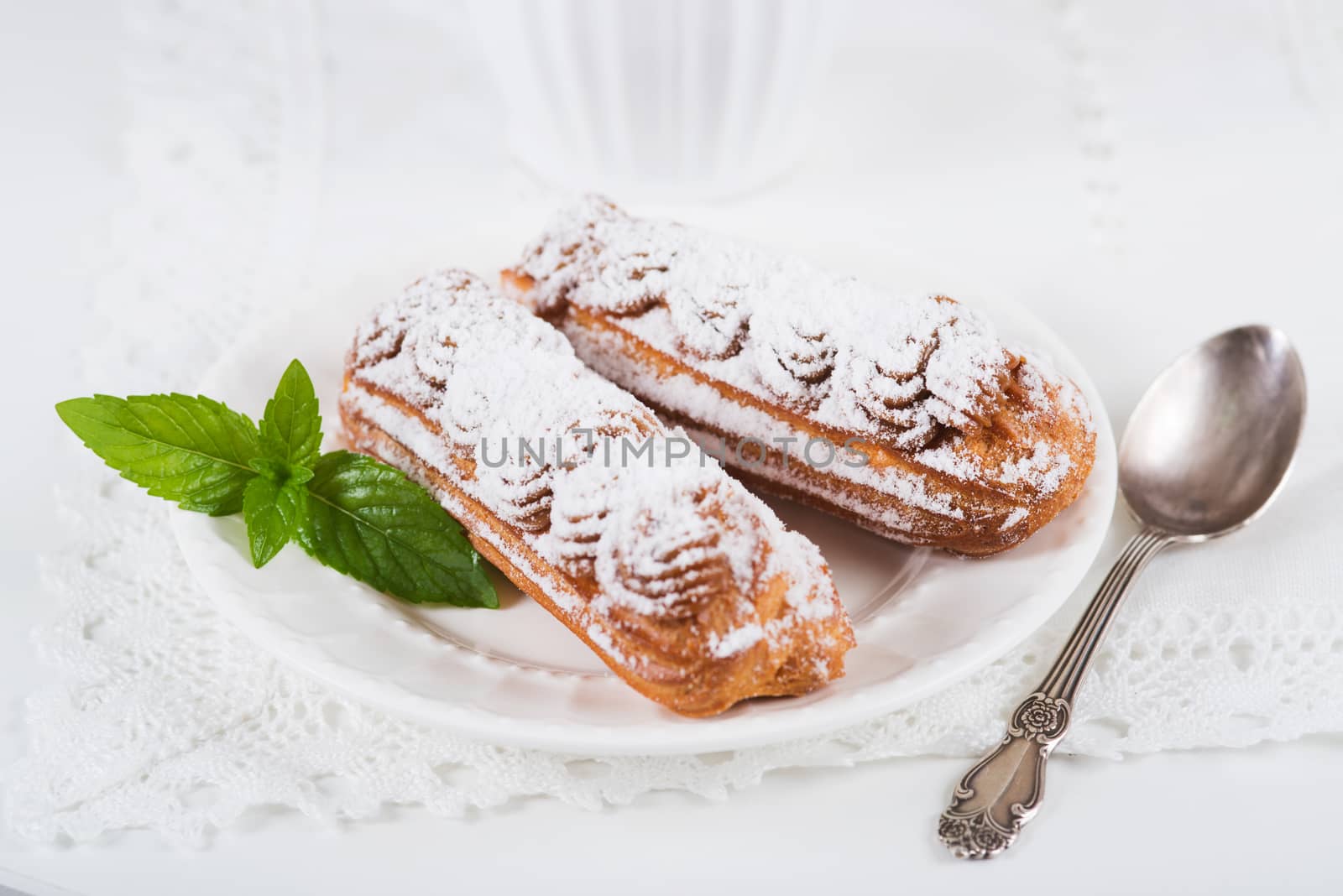 Eclairs on plate on a table by kzen