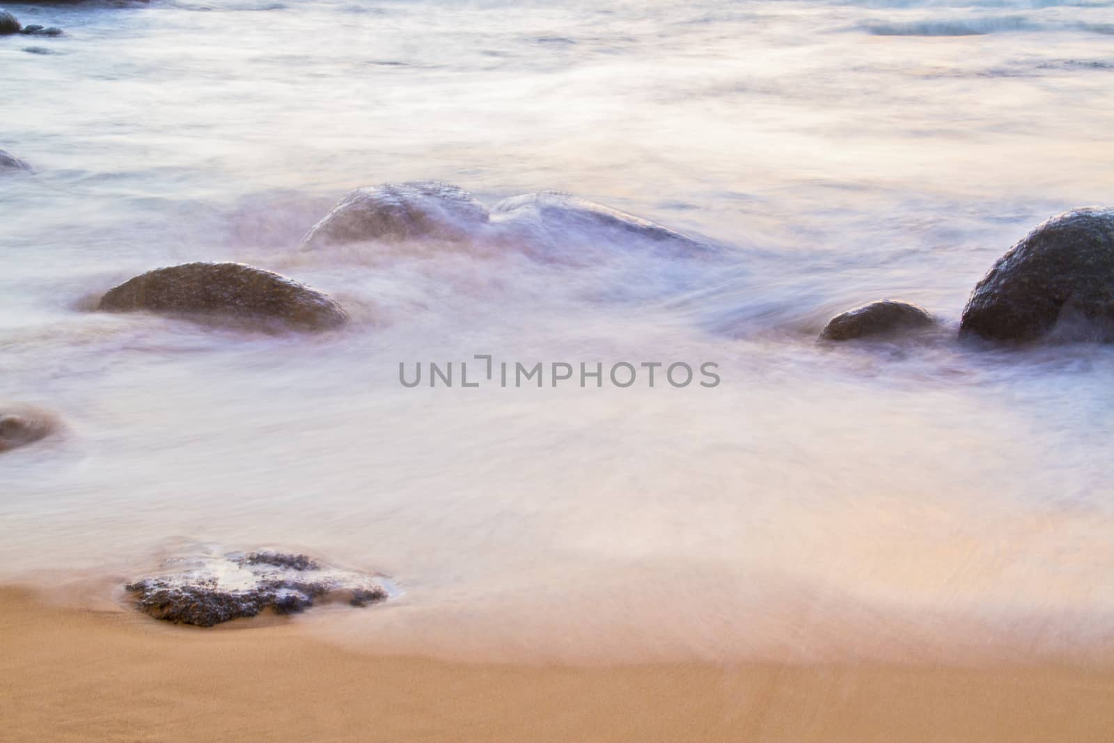  The sea and the rocks at sunset.( blur)