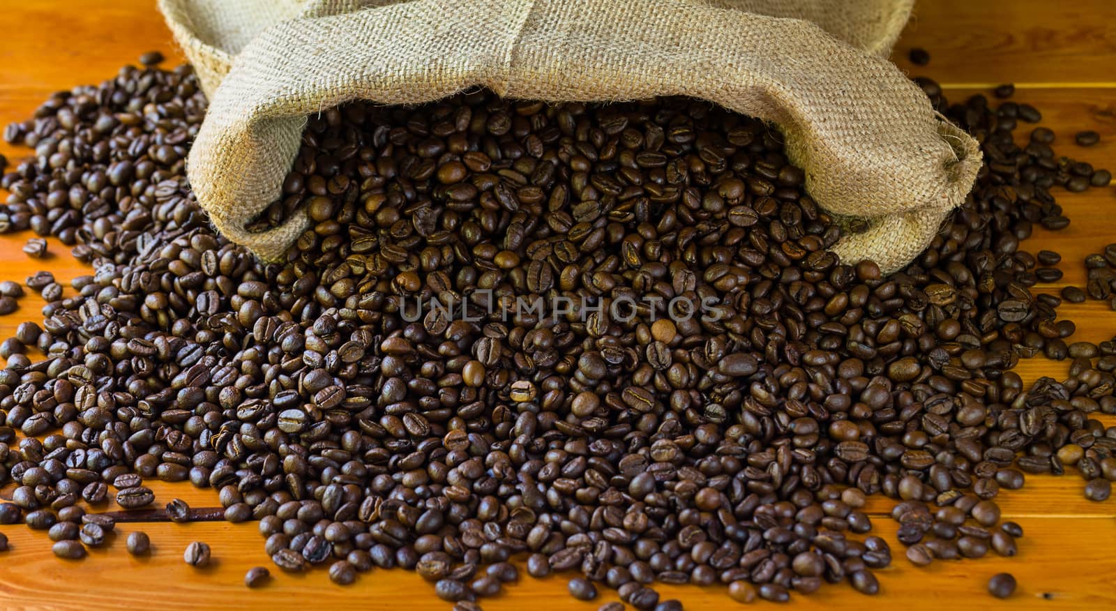 Coffee-beans in jute on wood background