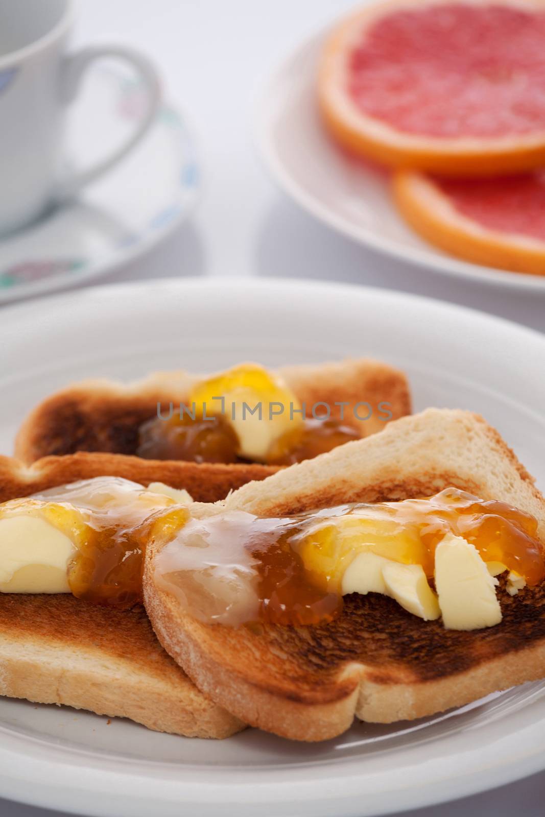 French toast and sliced orange on white tablecloth by LuigiMorbidelli