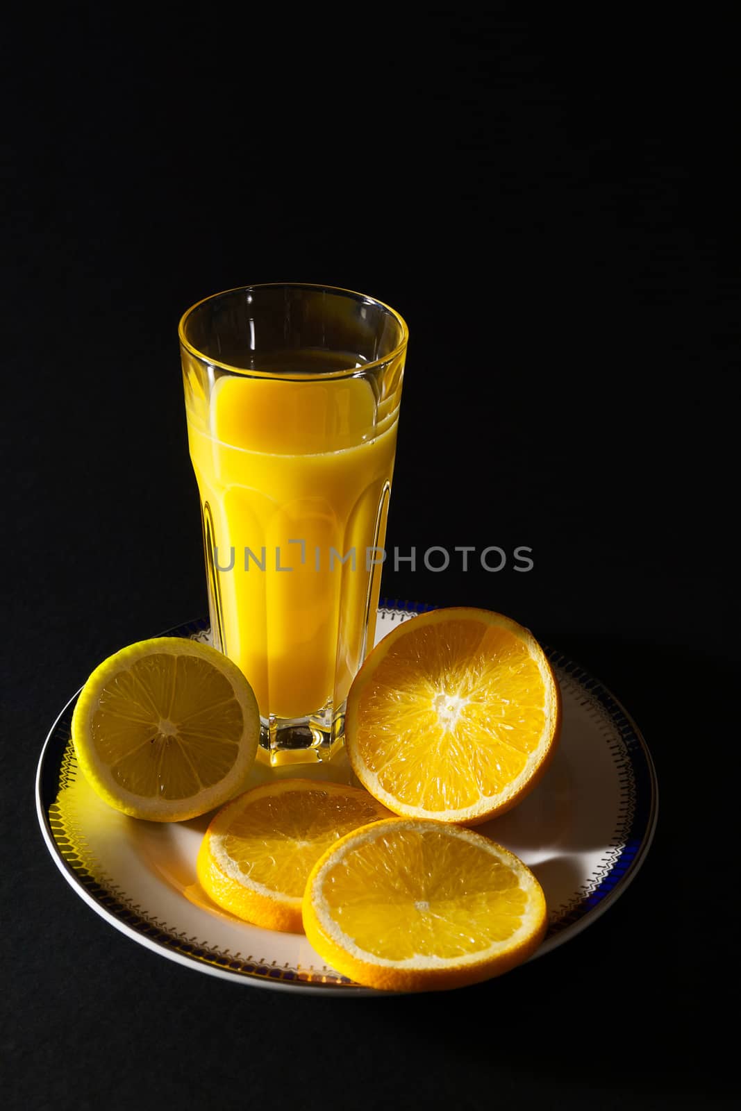 An orange juice served in a tall glass