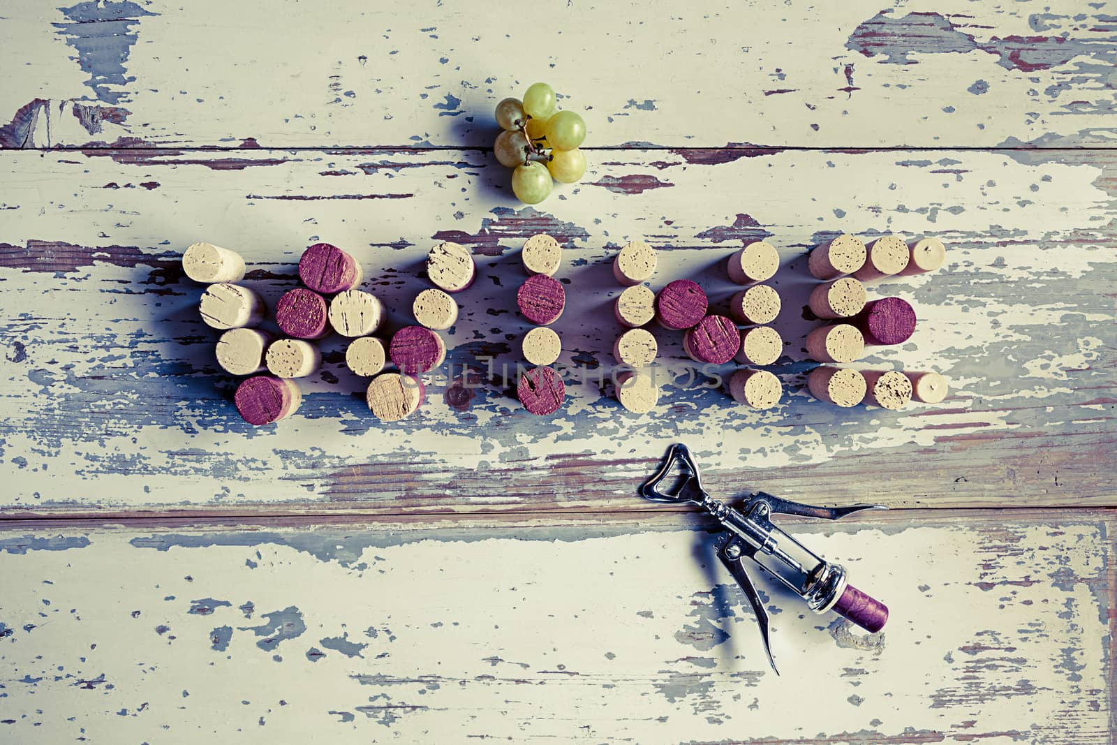 The word wine written with corks on a wood background