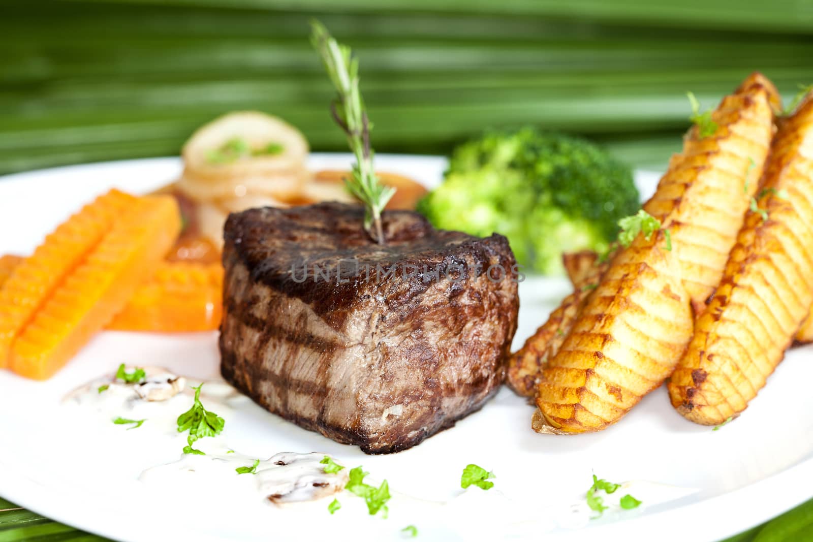 Grilled beefsteak, baked potatoes and vegetables