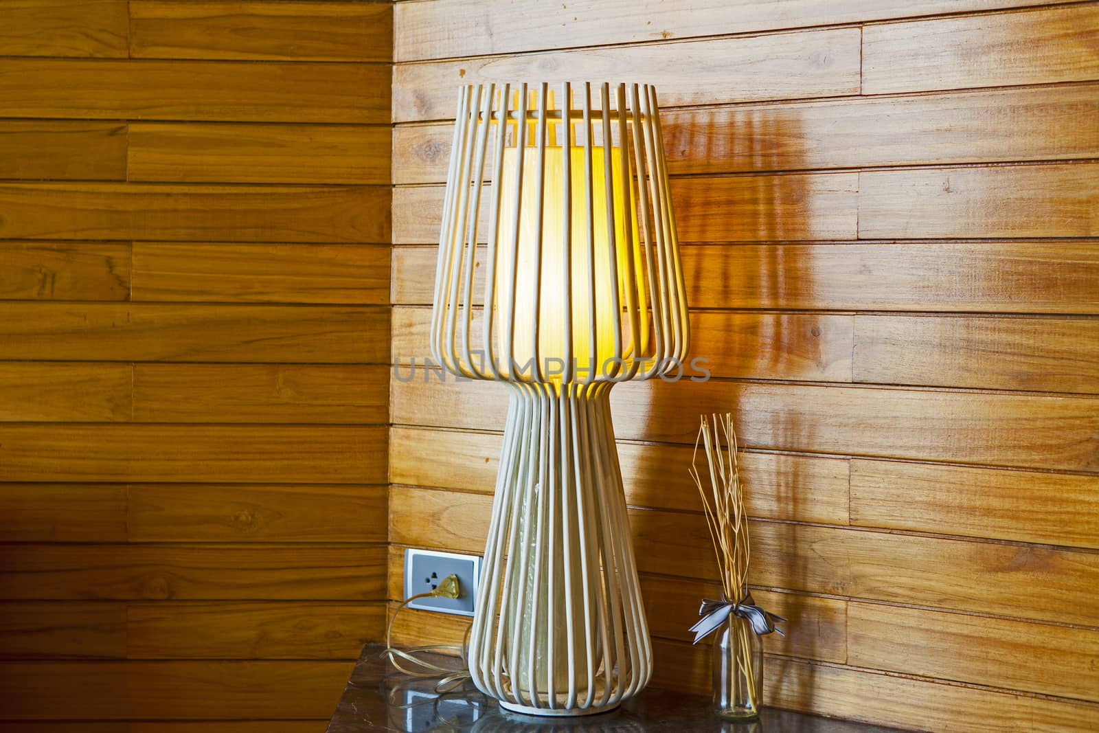 The interior of a bedroom with a lamp.