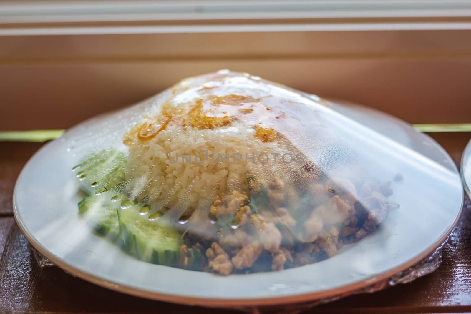 Rice topped with stir-fried chicken, basil and fried egg, fried stir basil with minced chicken on white background