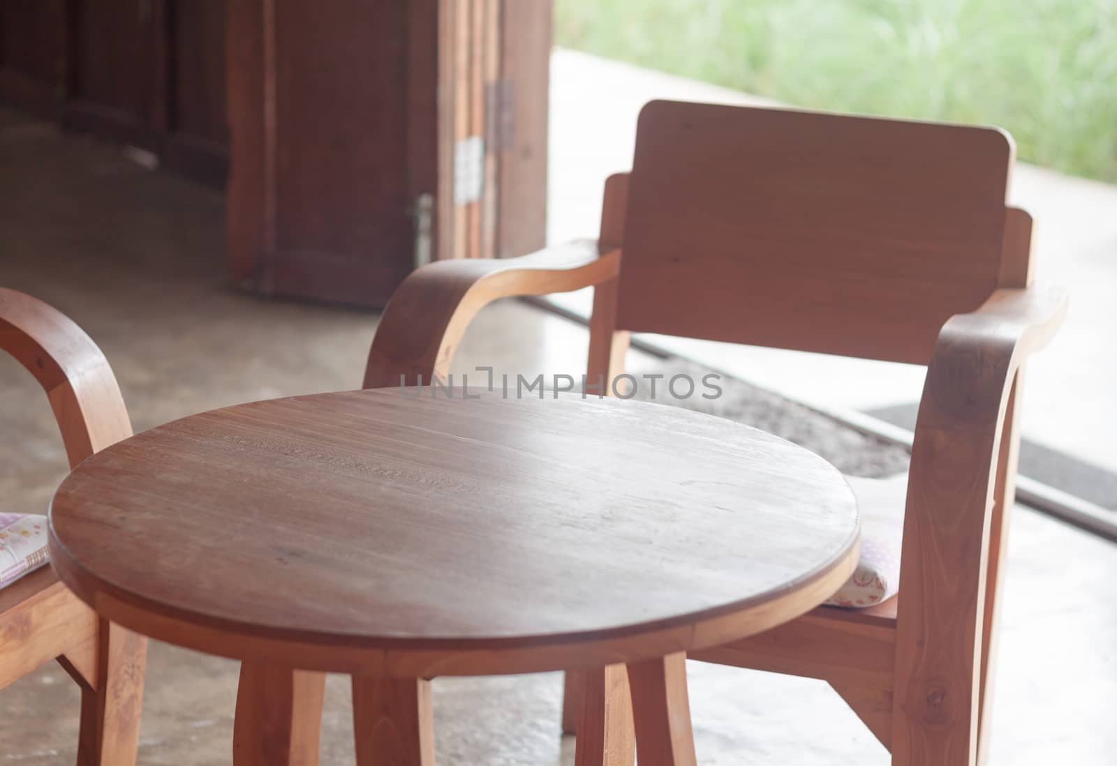 Wooden table and chairs in coffee shop, stock photo