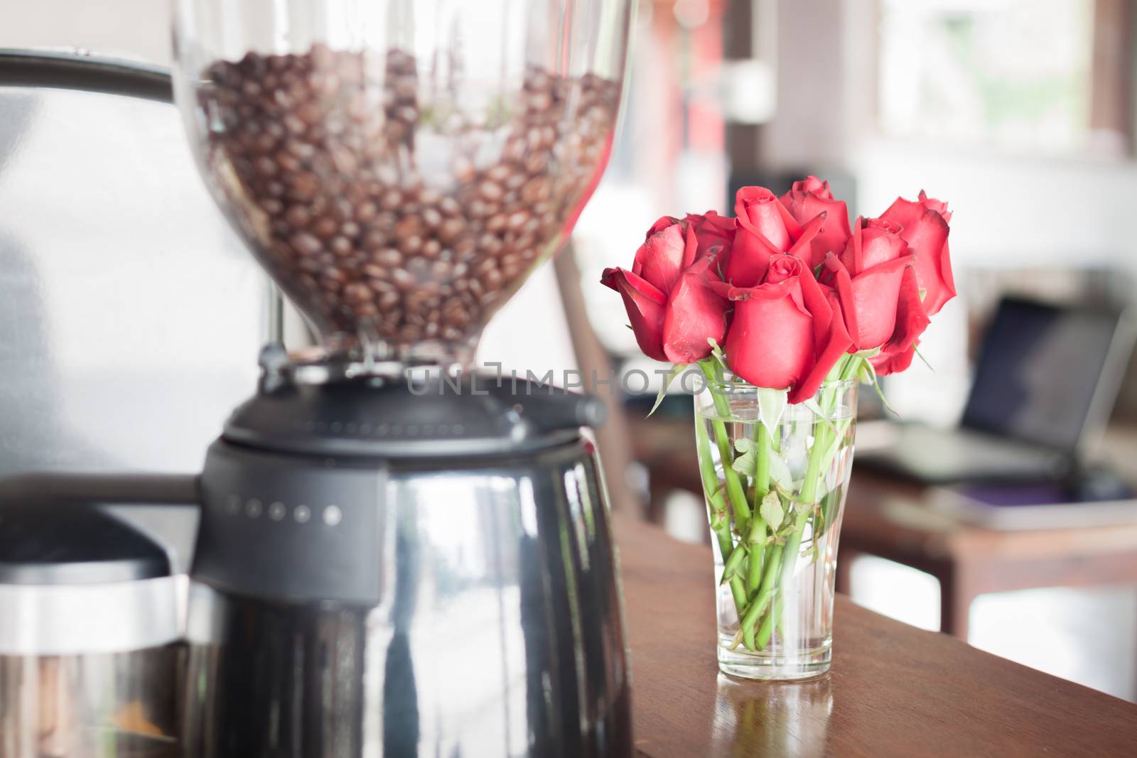 Red roses in coffee shop, stock photo