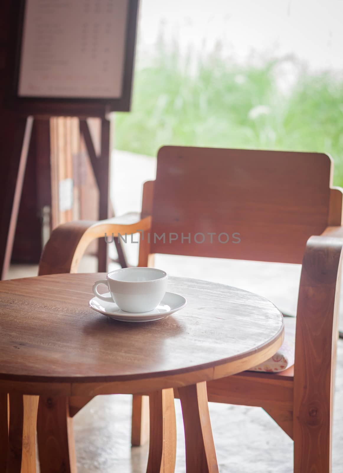 Coffee cup on table in coffee shop by punsayaporn