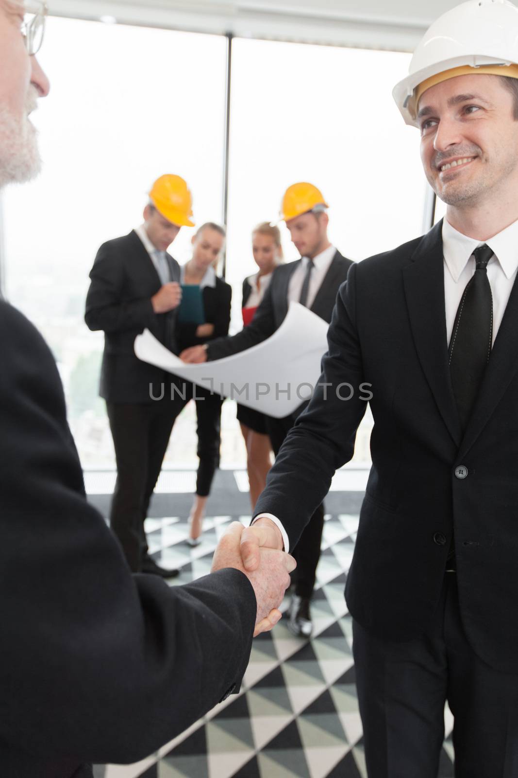 Handshake of architect and investor by ALotOfPeople