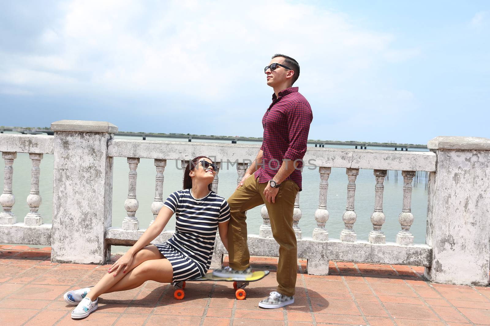 Young couple in love outdoor with skateboard.