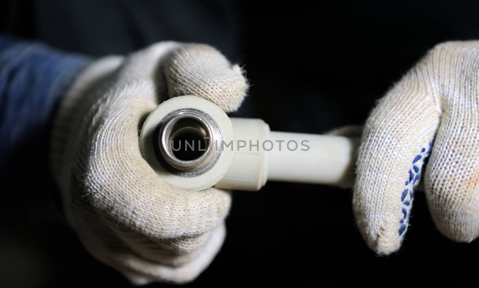 Plastic plumbing pipe in worker hand