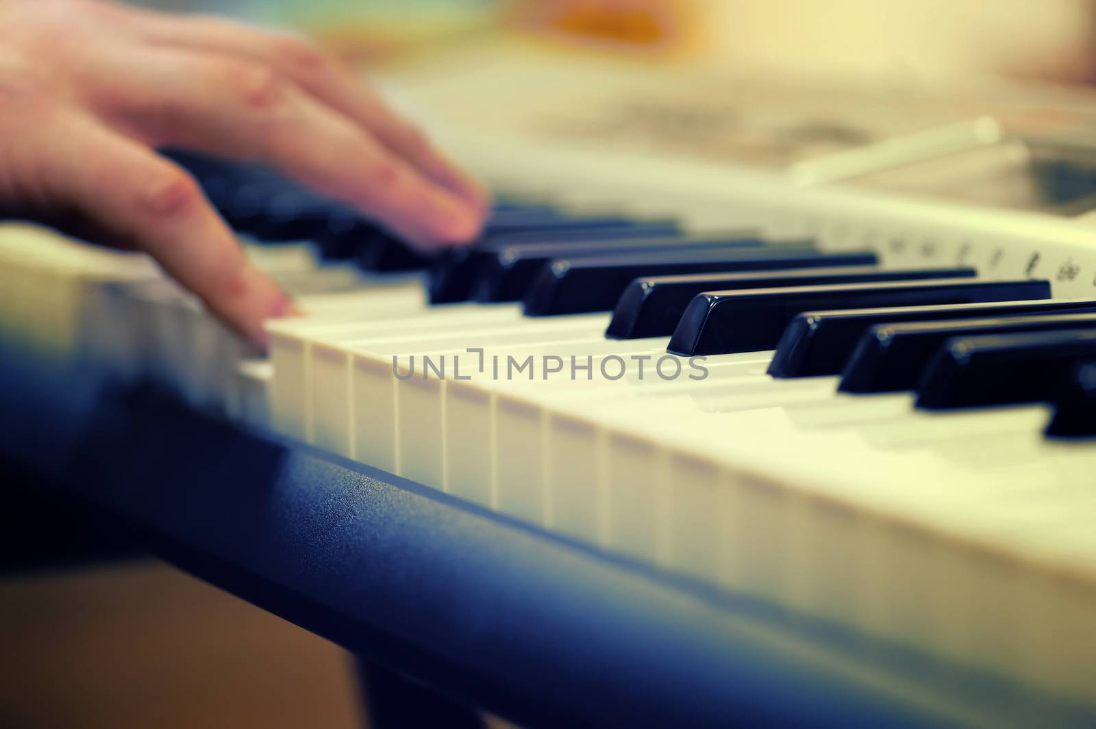 Defocusing hands on the keyboard of the piano