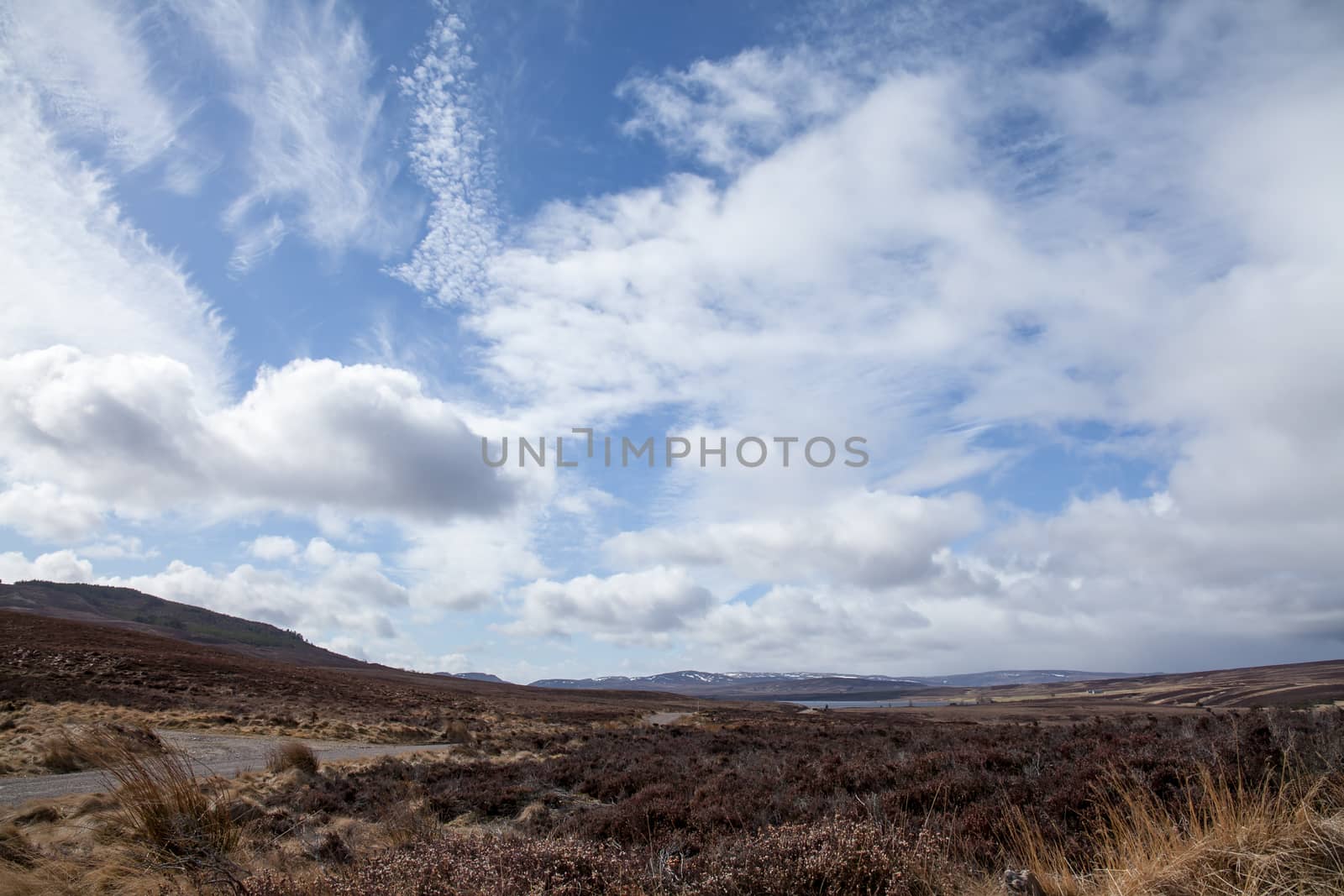Cloudy and blue sky and landscape near Lochindorb in the Scottish Highlands, during March.