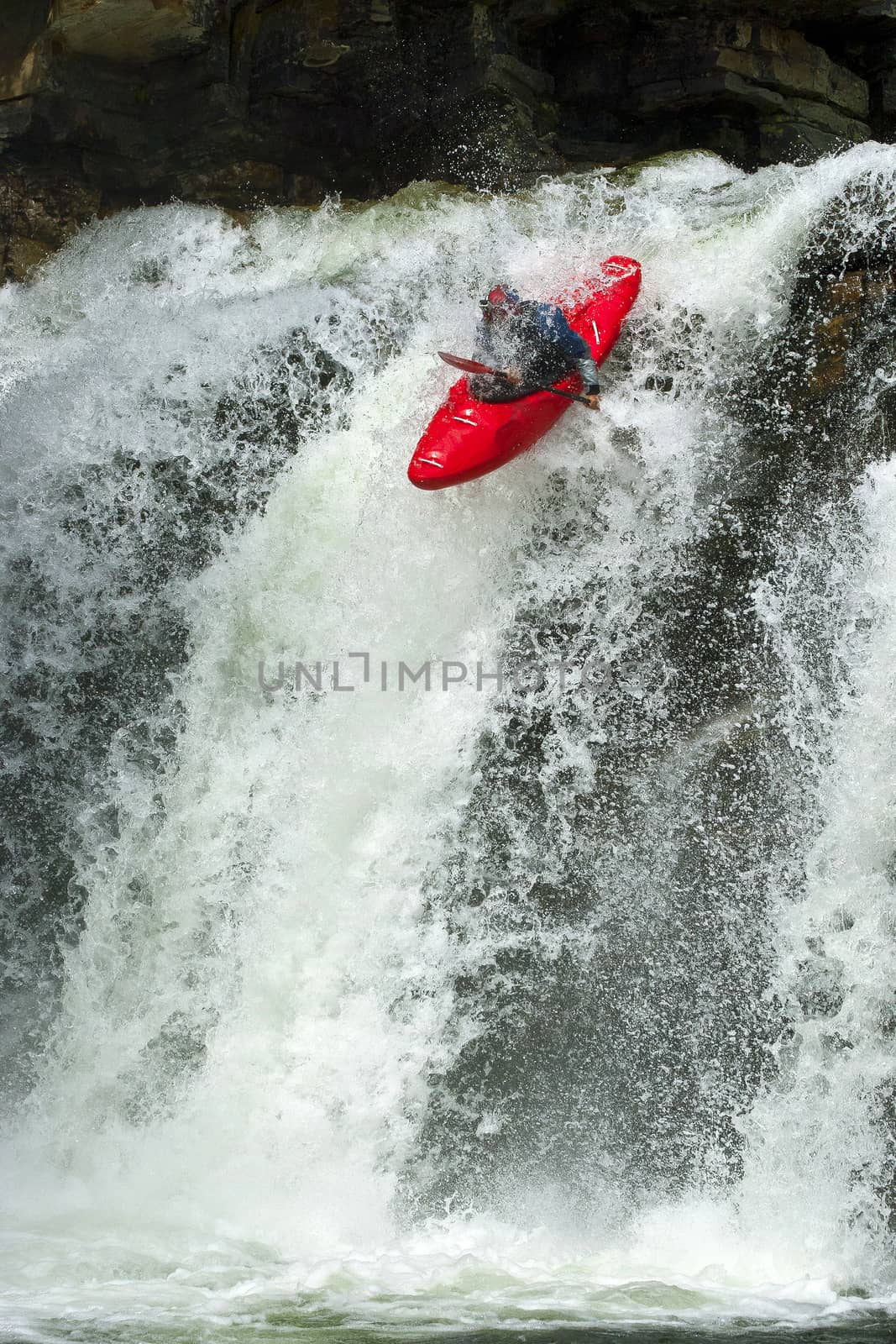 Kayaker in the waterfall by Chudakov