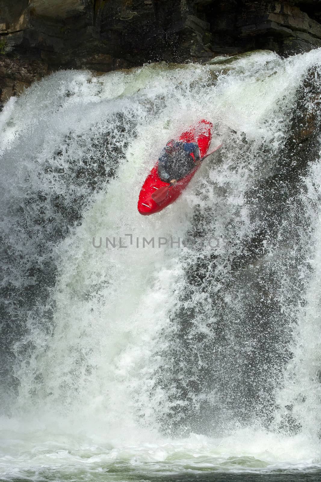 Kayaker in the waterfall by Chudakov