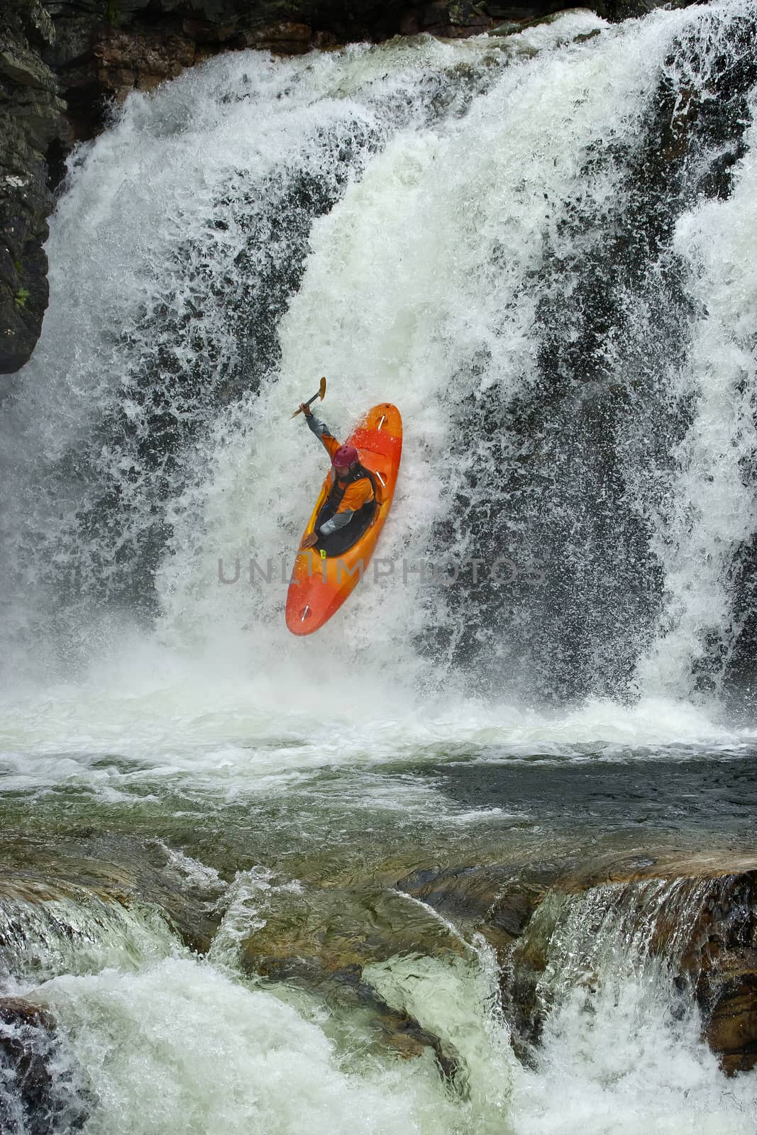 Kayaker in the waterfall by Chudakov