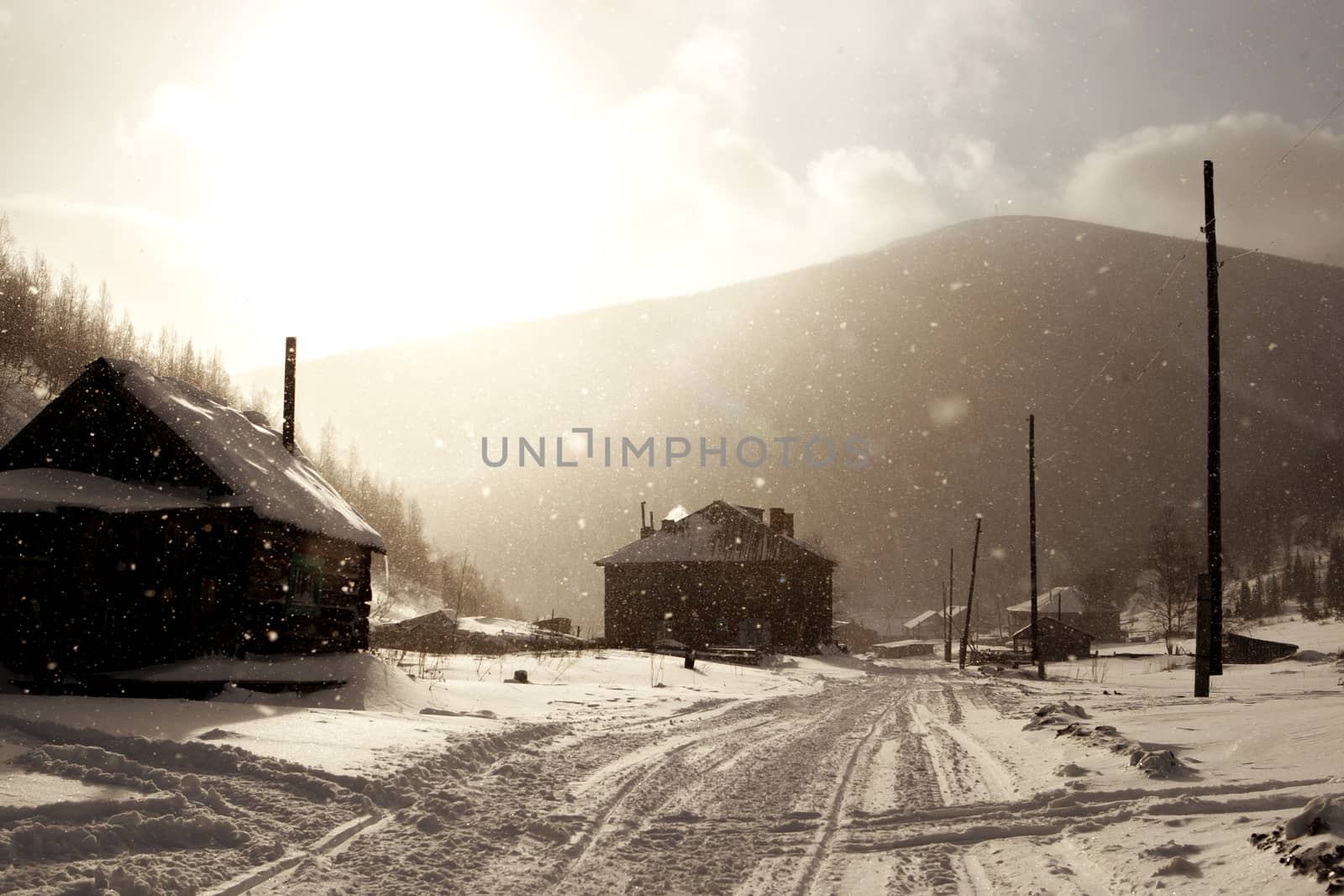 Snowy misty village street in Siberia in winter