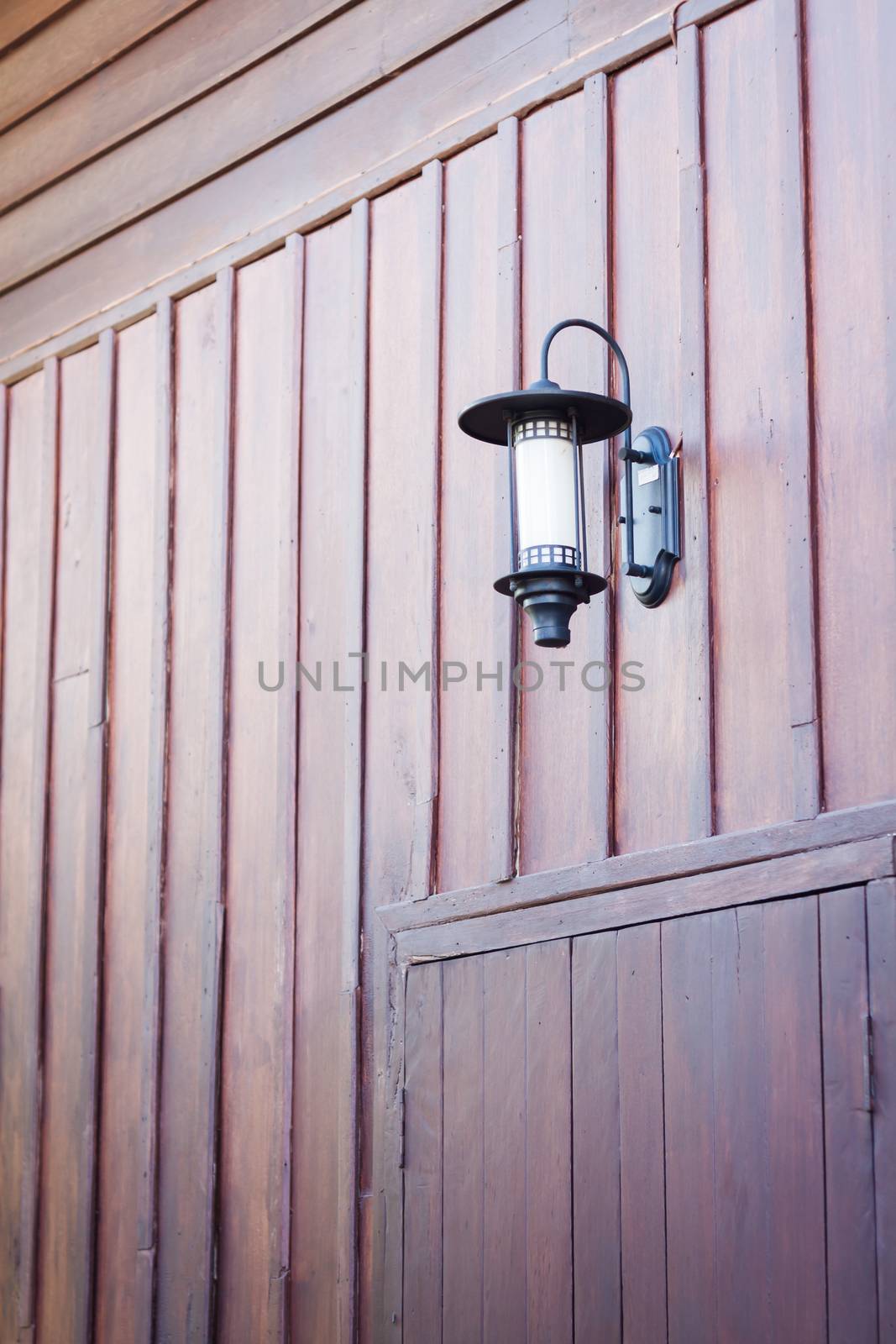 Lamp decorated on wooden wall by punsayaporn