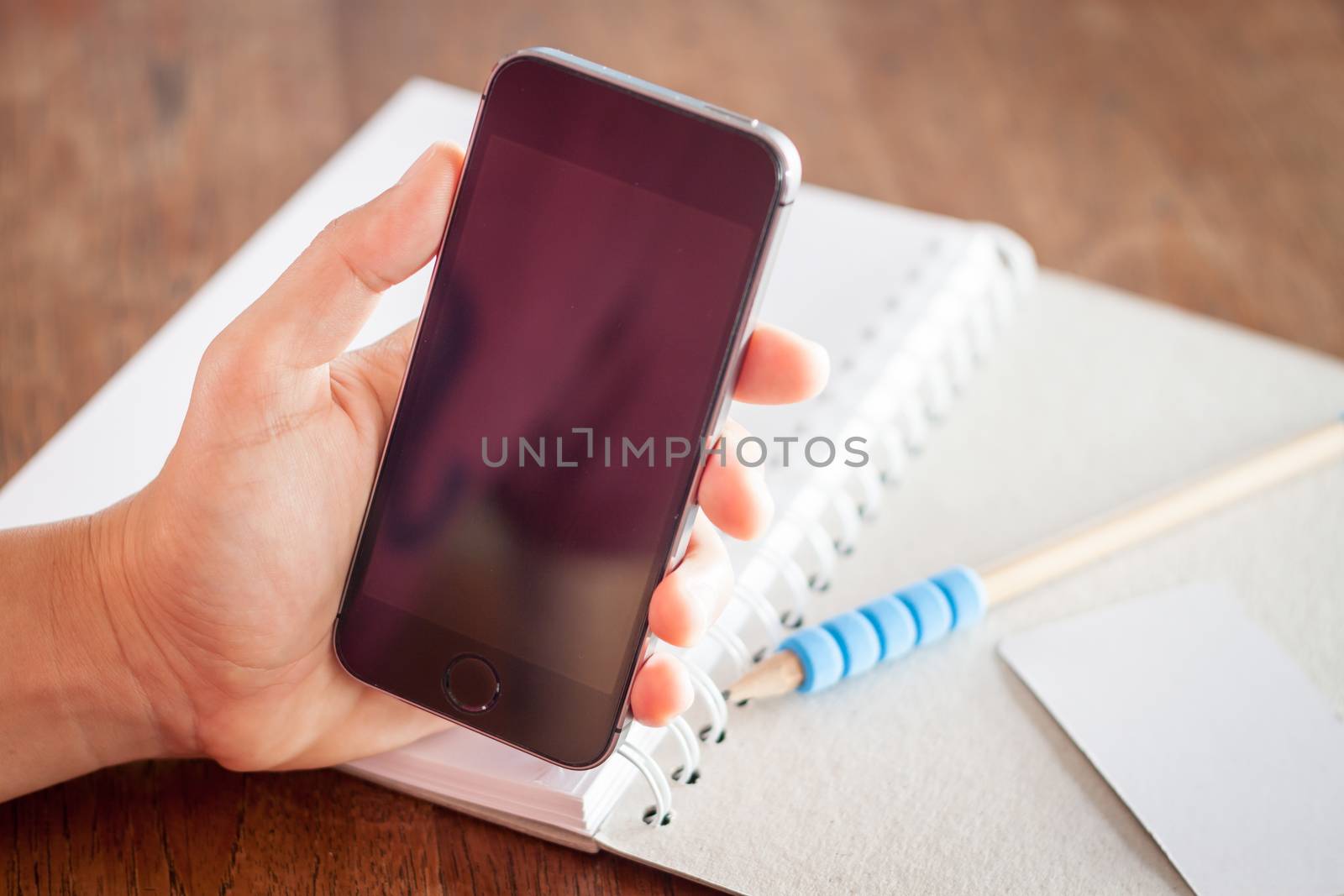 Smart phone in a woman's hand, stock photo