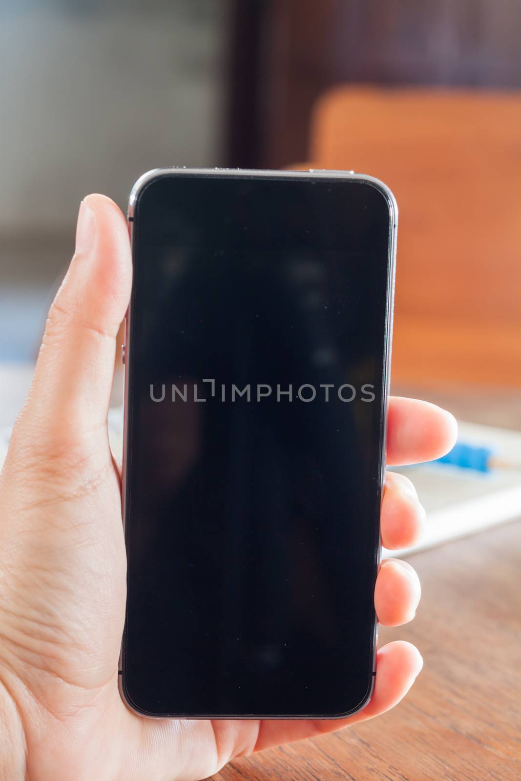 Smart phone in a woman's hand, stock photo