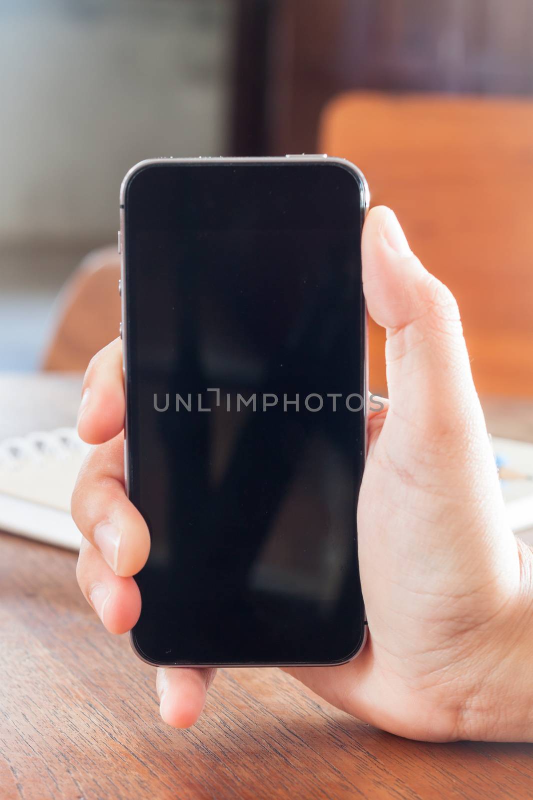 Smart phone in a woman's hand, stock photo