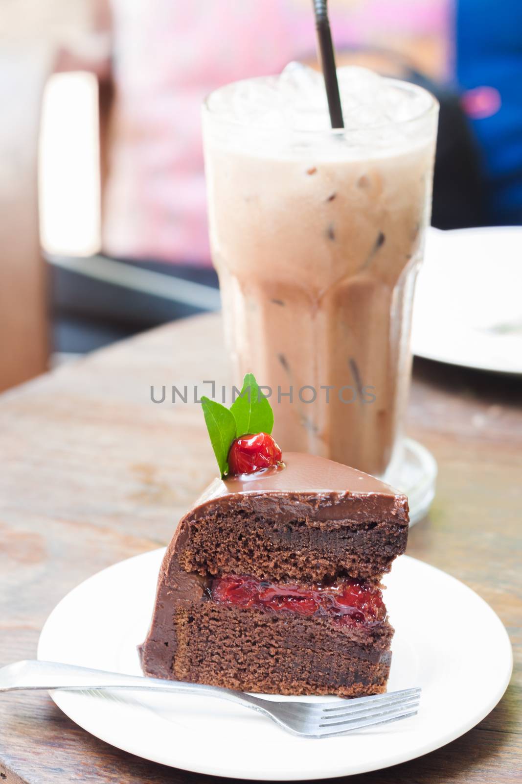 Piece of chocolate cake on white plate, stock photo