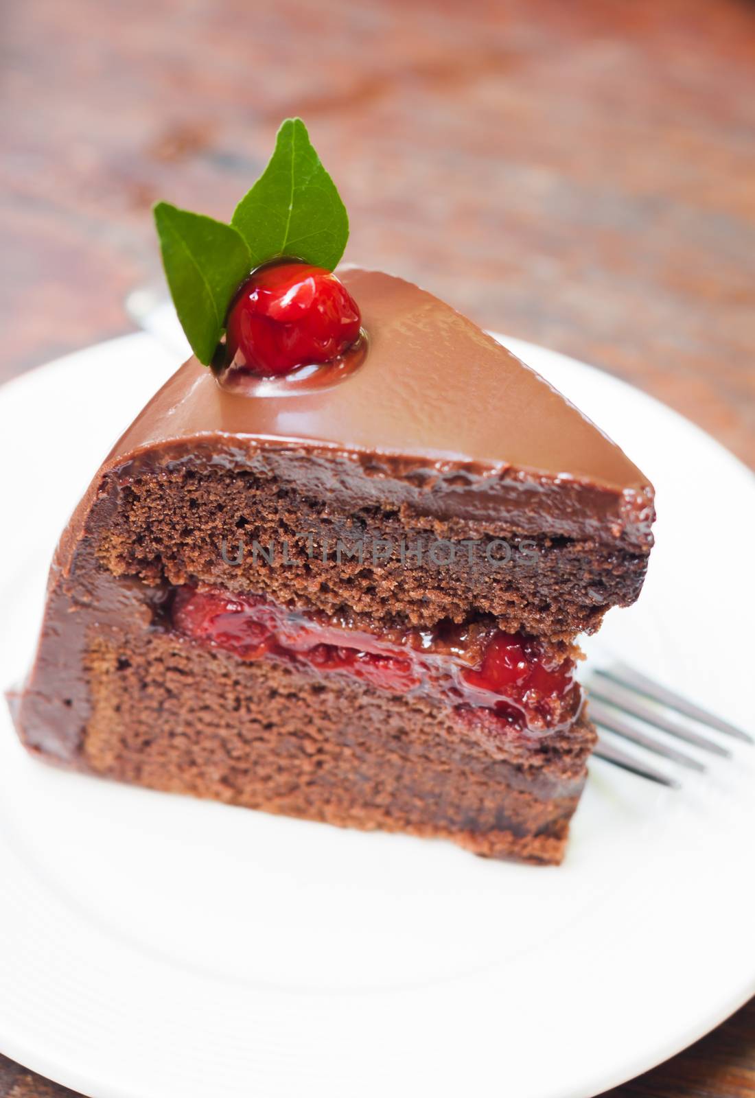 Piece of chocolate cake on white plate, stock photo