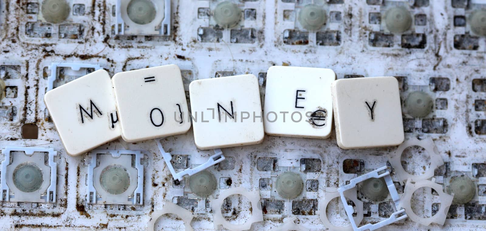 A close view of some keys on a dirty, yellowed keyboard.text money