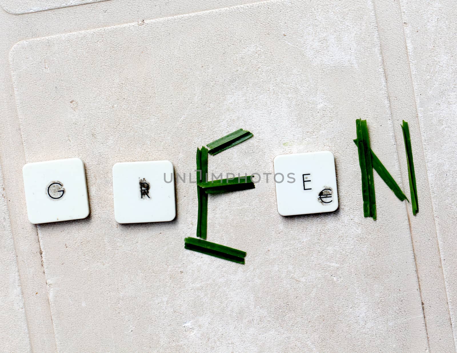 A close view of some keys on a dirty, yellowed keyboard.text green